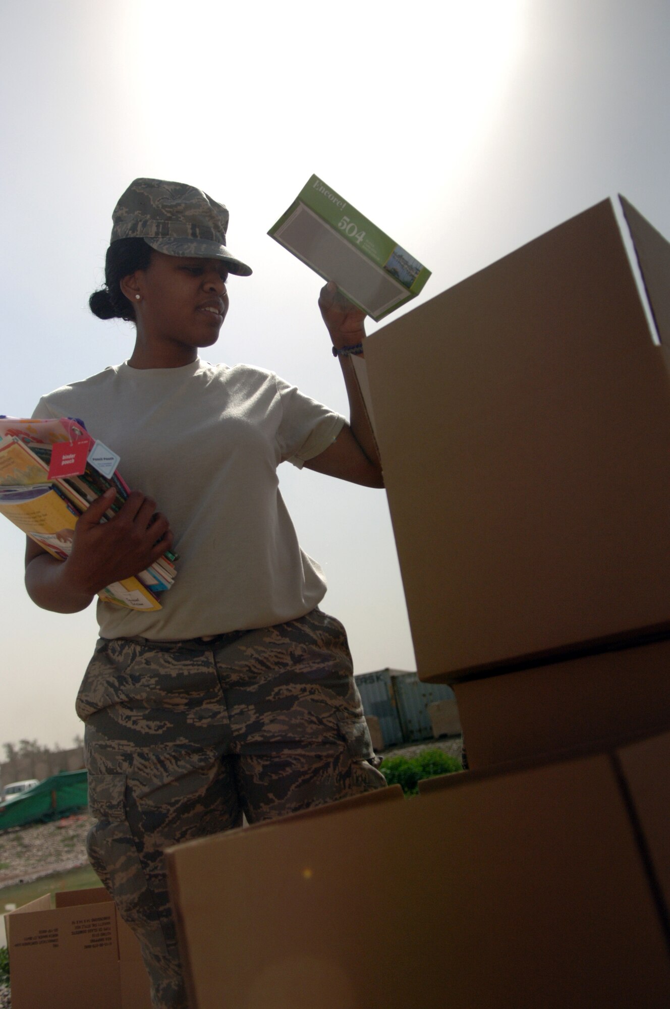 JOINT BASE BALAD, Iraq ? Airman 1st Class Lescotcia Smith, 332nd Expeditionary Force Support Squadron JBB lodging representative, sorts through  school supplies, organizing them in boxes before packing them up for distribution March 11 as part of a Kids of Iraq project. KOI is a non-profit organization dedicated to improving the lives of Iraqi children by fulfilling their basic needs and providing for a brighter future. Smith is deployed here from Fort Worth Naval Air Station Joint Reserve Base, Texas, and is a native of Opelouss, La. (U.S. Air Force photo/Staff Sgt. Dilia Ayala)