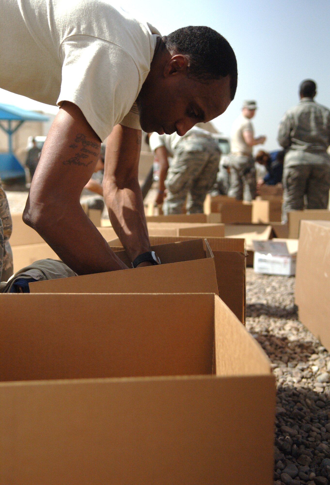 JOINT BASE BALAD, Iraq ? Senior Airman Robert Hughes, 332nd Expeditionary Force Support Squadron transient lodging representative, sorts through toys and children?s clothes and organizes them in boxes March 11 as part of a Kids of Iraq project. KOI is a non-profit organization dedicated to improving the lives of Iraqi children by fulfilling their basic needs and providing for a brighter future. Hughes is deployed from Fort Worth Naval Air Station Joint Reserve Base, Texas, and is a native of Arlington, Texas. (U.S. Air Force photo/Staff Sgt. Dilia Ayala)