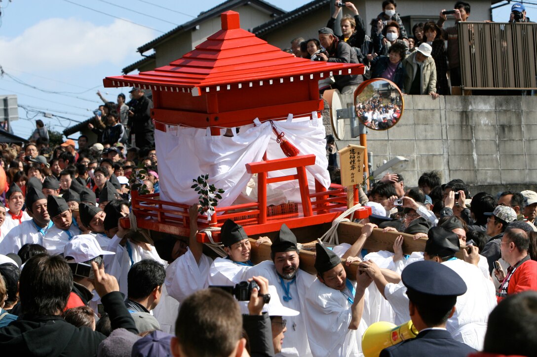 Festival participants make their way to the Tagata Shinto shrine with a wooden statue of Takeinandene-no-mikoto, a local deity, during the Hounen Matsuri, or abundant year festival, in Komaki, Japan March 15.