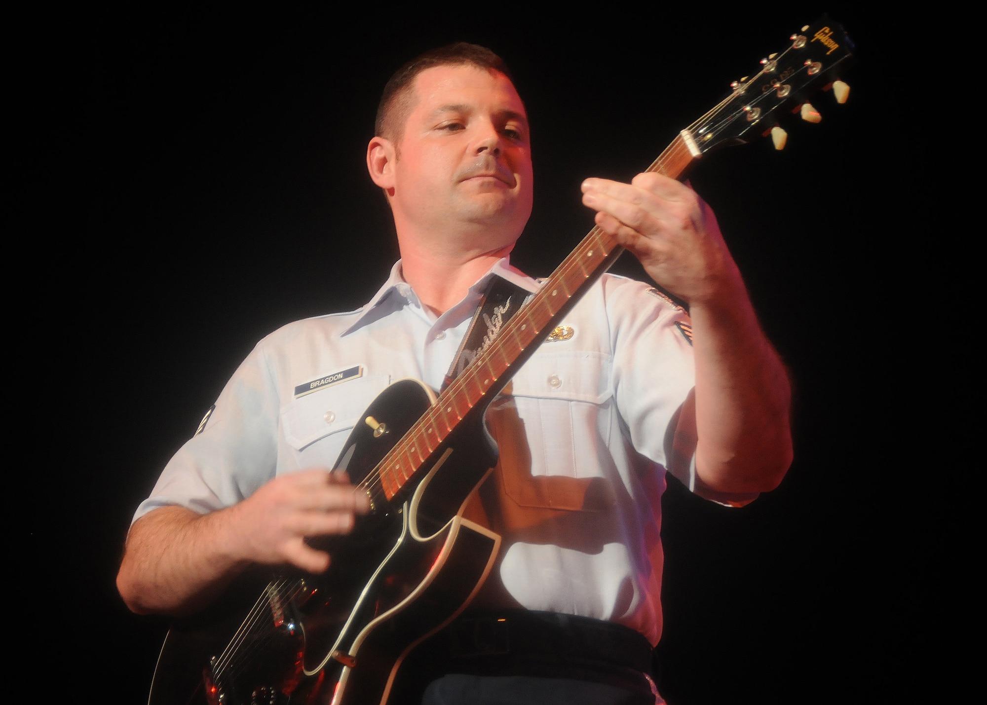 FUSSA CITY, Japan -- Staff Sgt. Daniel Bragdon, U.S. Air Force Band of the Pacific-Asia "Pacific Trends" guitarist, performs a solo March 15 during the Japan-U.S. Joint Concert, "Music Across the Border." The concert took place at Fussa Citizens' Hall and around 850 Japanese and American guests attended the concert. (U.S. Air Force photo/Airman Sean Martin)