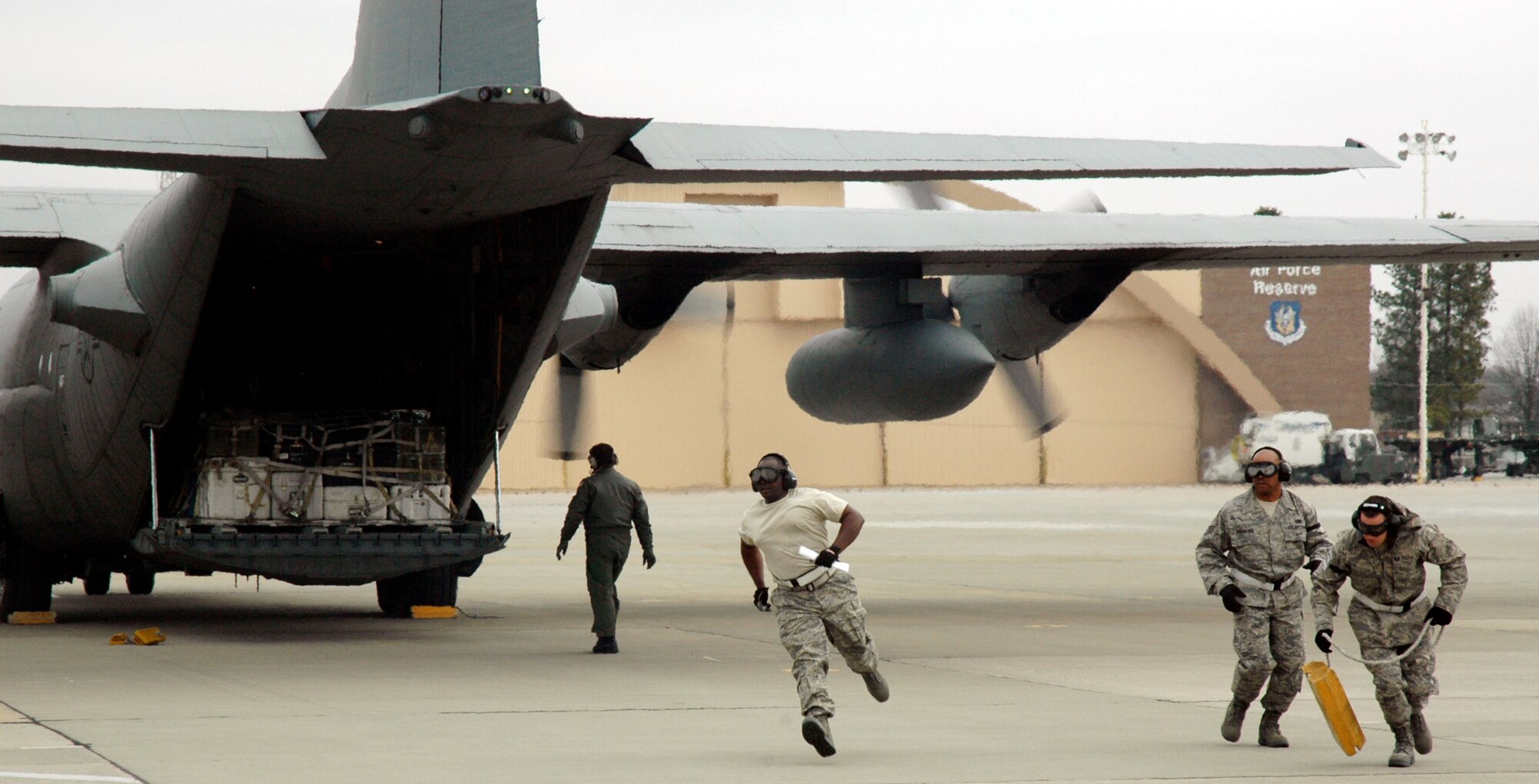 Members of the 38th Aerial Port Squadron sprint to the finish in an engine running on/offload event during the 22nd Air Force Aerial Port ROUNDUP at Dobbins Air Reserve Base, Ga., March 14, 2009. During the event, 18 aerial port squadrons from the 22nd AF vied for the top spot in six events, which tested their efficiency and safety in various aerial port functions. (U.S. Air Force photo/Capt. Bryan Lewis)