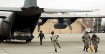 Members of the 38th Aerial Port Squadron sprint to the finish in an engine running on/offload event during the 22nd Air Force Aerial Port ROUNDUP at Dobbins Air Reserve Base, Ga., March 14, 2009. During the event, 18 aerial port squadrons from the 22nd AF vied for the top spot in six events, which tested their efficiency and safety in various aerial port functions. (U.S. Air Force photo/Capt. Bryan Lewis)