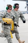 Determined to win, members of 32nd APS perform an engine running on/off load at the 22nd AF ROUNDUP.