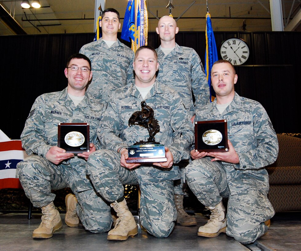 Members of the 27th Aerial Port Squadron beam with pride holding their bucking bronco Overall Winner trophy and their In-Transit Visibility Winner belt buckle March 15 at the first 22nd Air Force Aerial Port ROUNDUP. Members of the team include, from left, Staff Sgt. Jesse Werner, Staff Sgt. Justin Melroy, Staff Sgt. Matthew Russell, Master Sgt. Damion Kosmosky and Senior Airman Troy Olsen. This group of traditional reservists practiced since November during unit training assemblies and additional weekends to prepare for the competition at Dobbins Air Reserve Base, Ga. Four of the five members will deploy to Southwest Asia in the coming months. (U.S. Air Force photo/Staff Sgt. Steve Lewis)