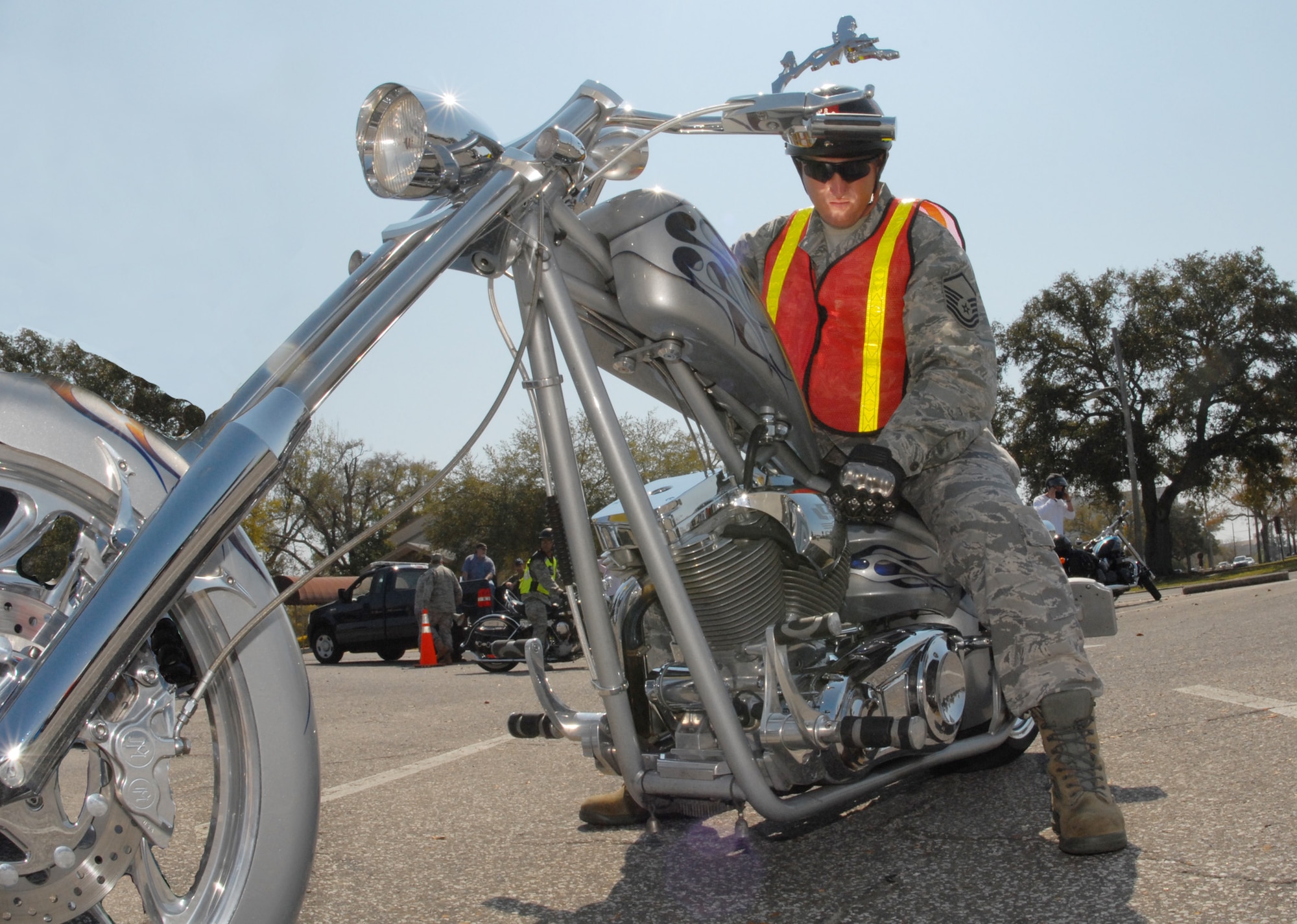 Master Sgt. Chad Wilkey, 96th Logistics Readiness Squadron, adjusts his 'award-winning' custom chopper before the group ride at the Team Eglin Motorcycle Safety Day March 13 at Eglin Air Force Base, Fla. The second annual event brought out approximately 280 riders to participate in safety discussions, riding skills competition and group ride. (Air Force illustration/Samuel King Jr.)