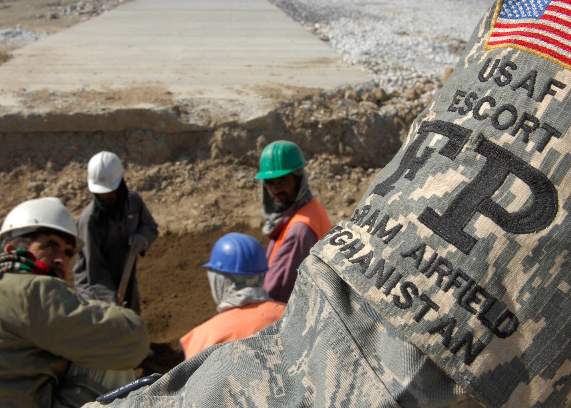 Airman 1st Class Linae Totten, 455th Expeditionary Civil Engineer Squadron force protection flight, escort third country nationals as well as local workers at Bagram Air Field, Afghanistan, March 12. There are approximately 70 Airmen that escort anywhere from 75 to 100 TCN's on any given day. FP Airmen are currently on a four-month deployment and are in charge of all TCN workers in secure areas. Airmen Totten is deployed from Barksdale, Air Force Base, La., and hales from Phenix, Ala. (U.S. Air Force photo/ Senior Airman Erik Cardenas)(Released)