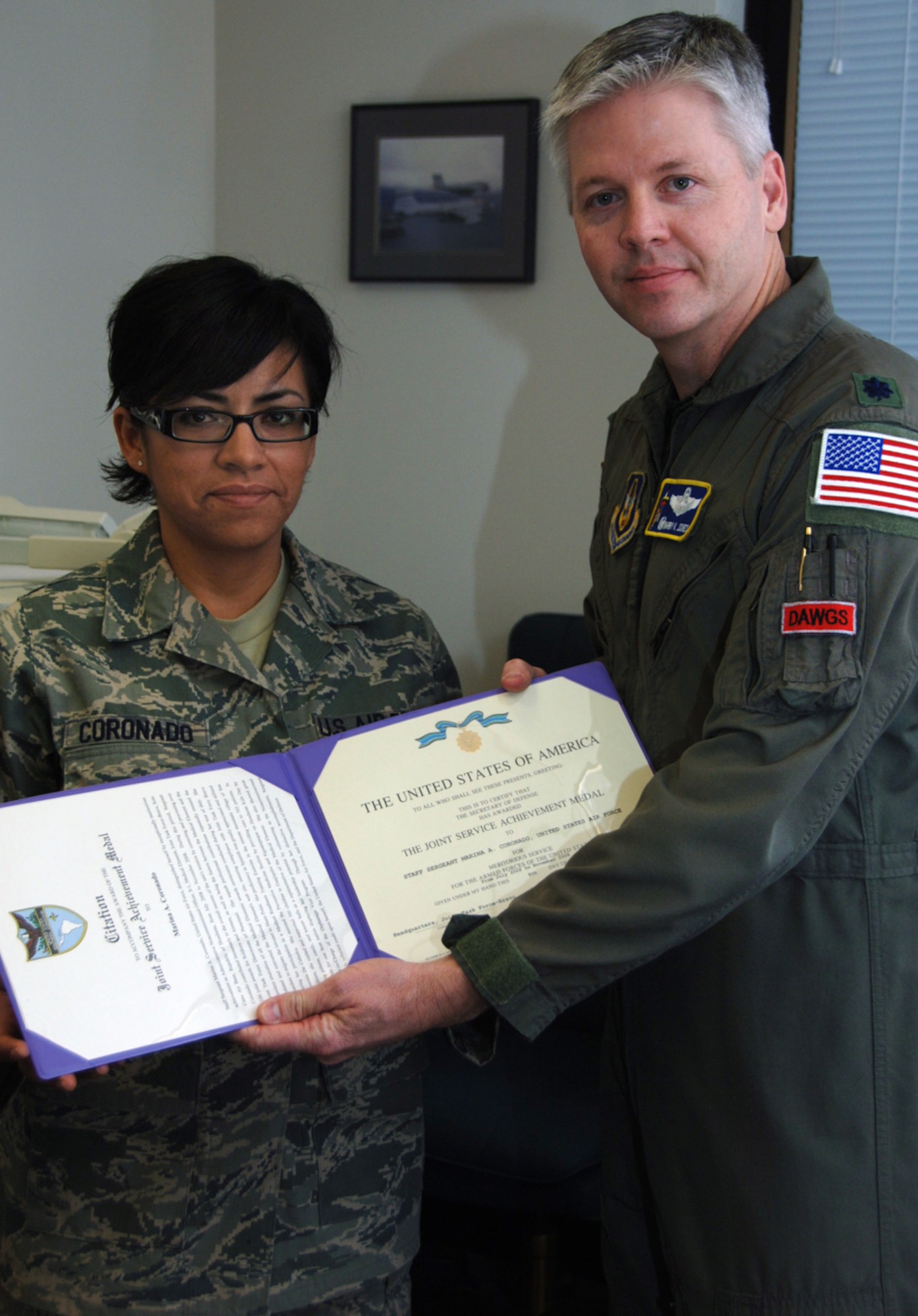 Lt. Col. Barry Jones presented Staff Sgt. Marina Coronado with a Joint Service Achievement Medal in March for her "exceptional" performance during a 125-day deployment to Honduras. Sergeant Coronado, a native of Matamoros, Mexico, is an information manager assigned to the 931st Operations Support Flight. Colonel Jones is the flight's commander. (U.S. Air Force photo/Senior Airman Connor Burkhard) 