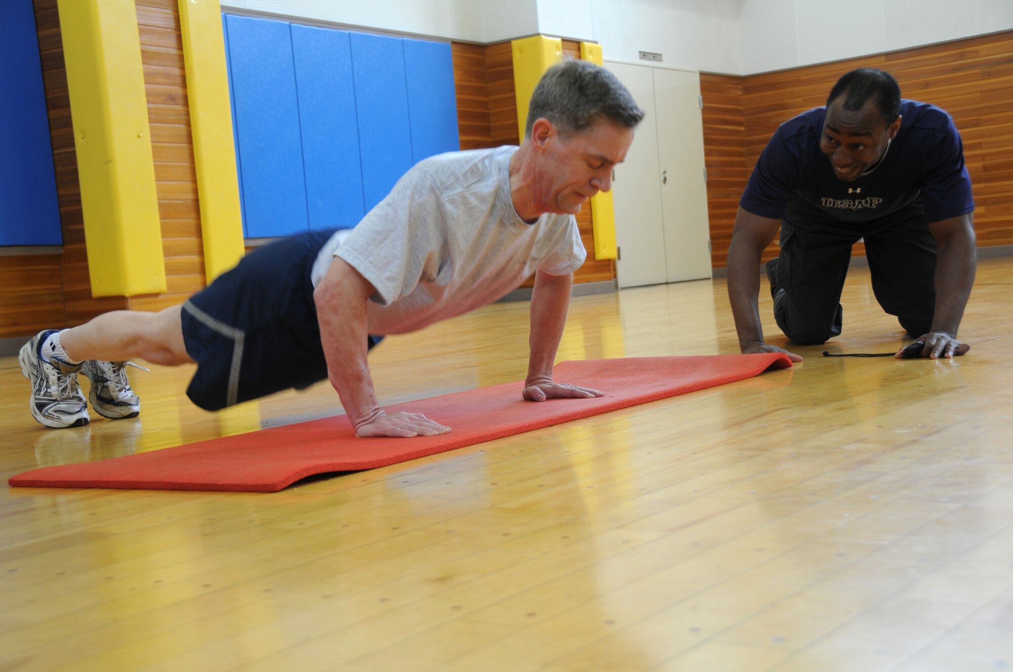 MISAWA AIR BASE, Japan -- Orlando Nurse, Health and Wellness Center health technician, counts pushups for Lt. Col. Scott Marchand, 35th Fighter Wing Judge Advocate, during a fitness assessment March 10, 2009. As part of a Pacific Air Forces initiative, the HAWC has taken over fitness assessments and the Fitness Improvement Program. (U.S. Air Force photo by Staff Sgt. Rachel Martinez)
