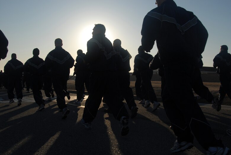Edwards Airmen run during an installation fitness run along FitzGerald Boulevard March 13. More than 700 Airmen, both military and civilian, participated in the event. The formation run was also used as an avenue for the 95th Communications Group to remind base personnel of network security. FitzGerald Boulevard was lined with boards providing information about what Airmen can do to ensure network security. (U.S. Air Force photo/Senior Airman Julius Delos Reyes)