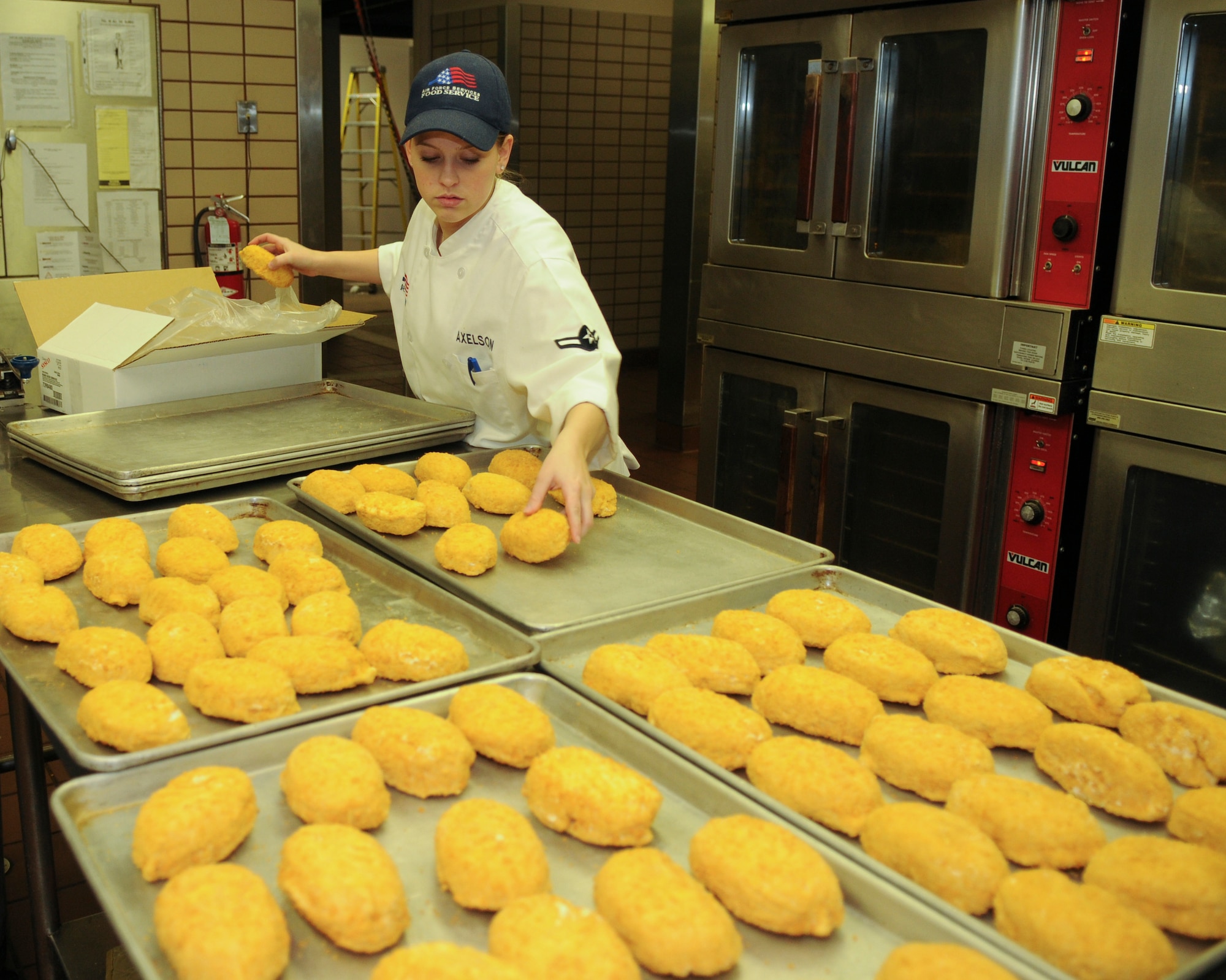 Airman Christy Axelson 354th Force Support Squadron prepares Chicken Cordon Bleu March 12, 2009, Eielson Air Force Base, Alaska.  Airman Axelson prepares enough chicken to feed hungry Airmen and other dining facility guests. (U.S. Air Force photo/Airman 1st Class Laura Max)