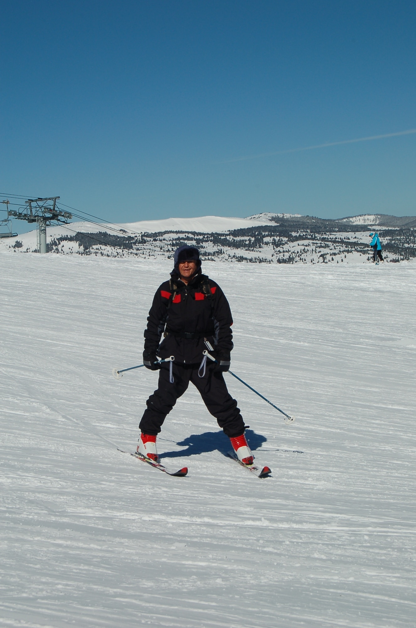 Retired Army Infantry Sergeant Fred Fisher skis on his first run of the day at Copper Mountain resort March 8. After recovering from a tumor that threatened the use of his legs, Sergeant Fisher harnesses the opportunity to be active by traveling to Copper Mountain resort with the Peterson Air Force Base Outdoor Adventures Program.  (Air Force photo by Thea Skinner)