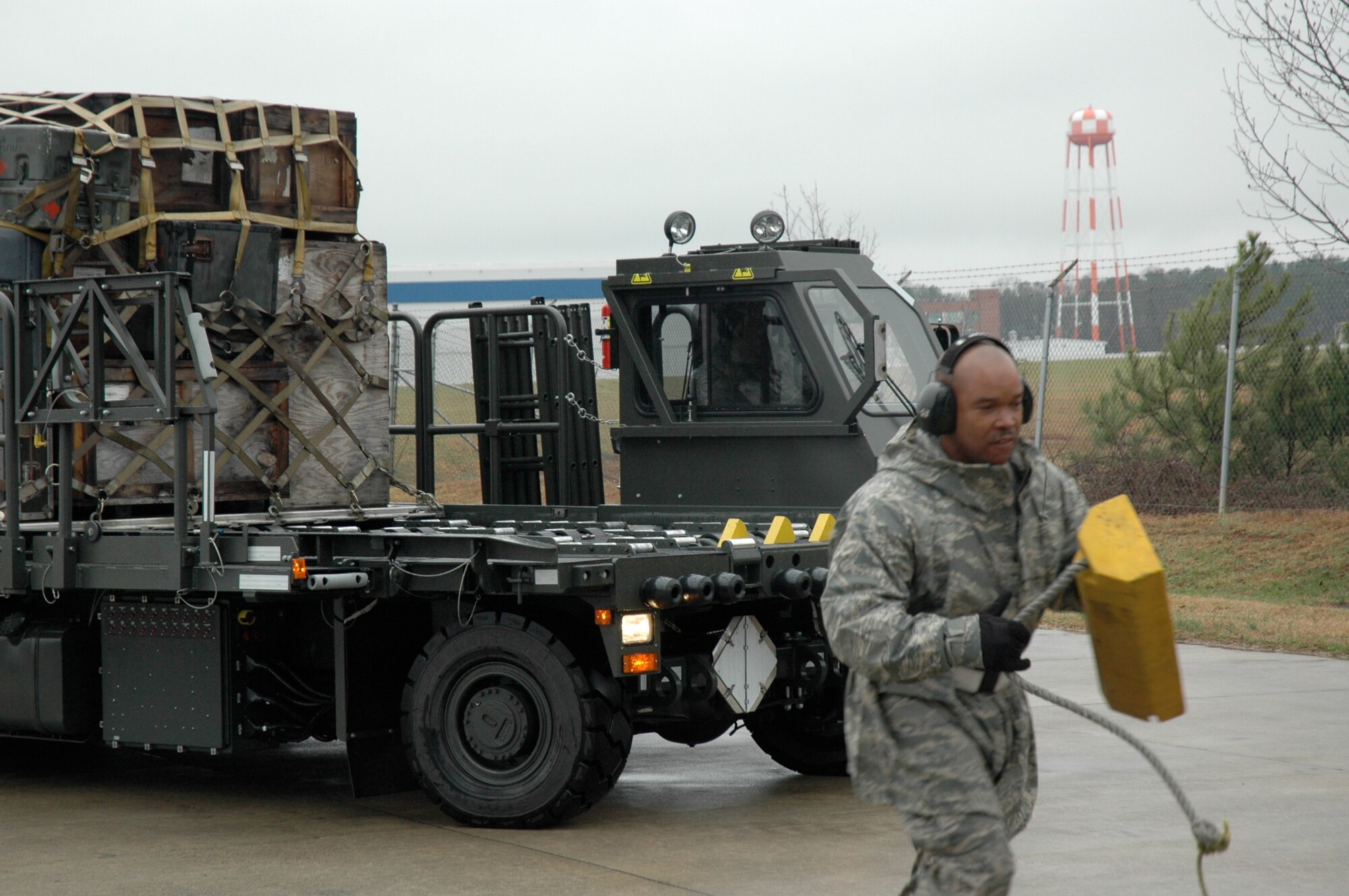With chaulk in hand, Staff Sgt. Gerald Brewster, 38th Aerial Port Squadron, races ahaed of a 25k Halverson loader during the material handling equipment event at the 22nd Air Force Aerial Port ROUNDUP at Dobbins Air Reserve Base in Atlanta March 15. During the competition 18 aerial port squadrons from the 22 AF vied for the top spot in six events, which test their efficiency and safety in various aerial port functions. (U.S. Air Force photo/Capt. Bryan Lewis)  