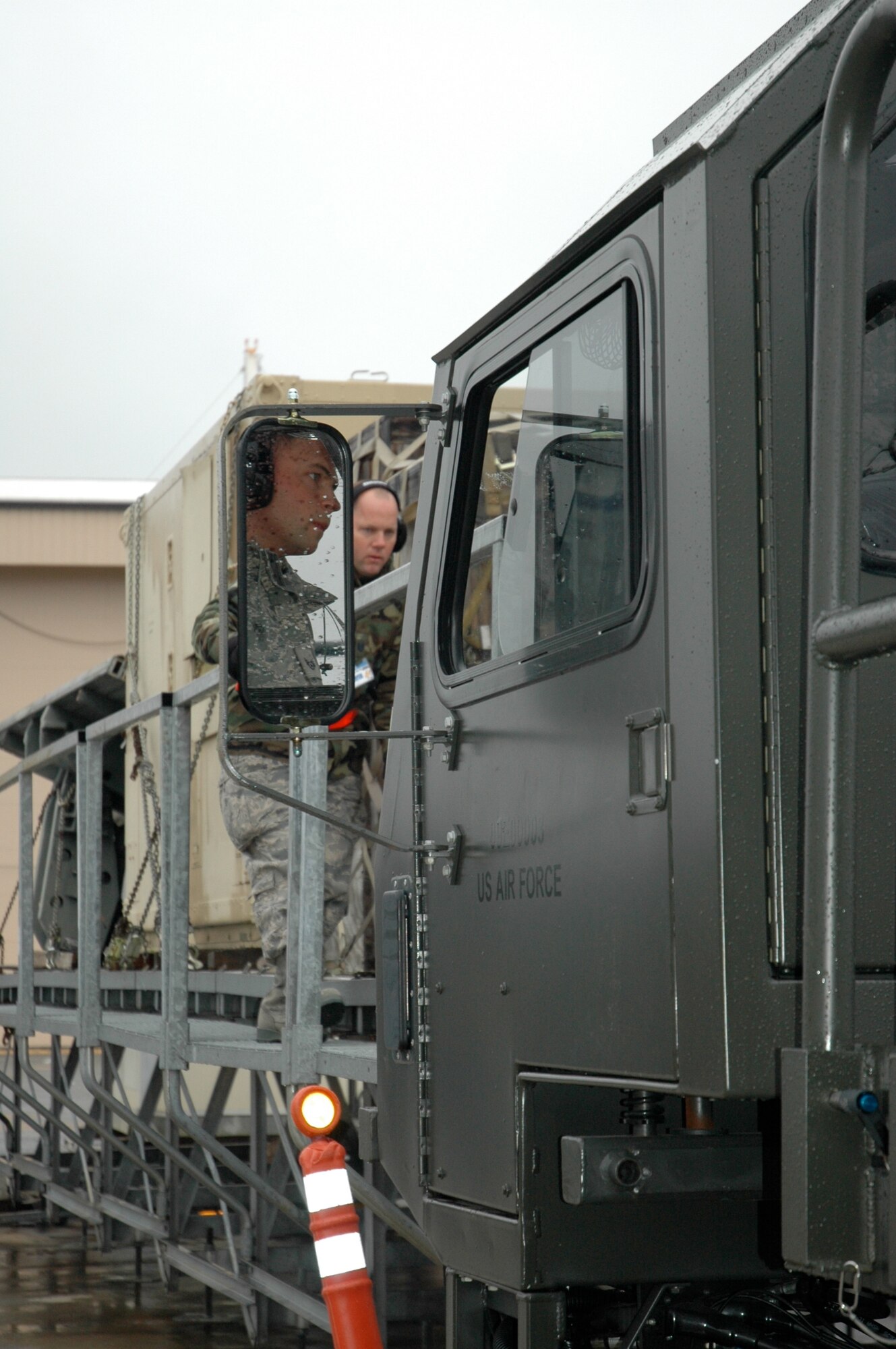 Tech. Sgt. Michael Gray, 38th Aerial Port Squadron, guides Staff Sgt. Stuart Music, 38 APS, as he drives a Halveson 25k loader during the material handling equipment event at the 22nd Air Force Aerial Port ROUNDUP at Dobbins Air Reserve Base in Atlanta March 15. During the competition 18 aerial port squadrons from the 22 AF vied for the top spot in six events, which test their efficiency and safety in various aerial port functions. (U.S. Air Force photo/Capt. Bryan Lewis)  