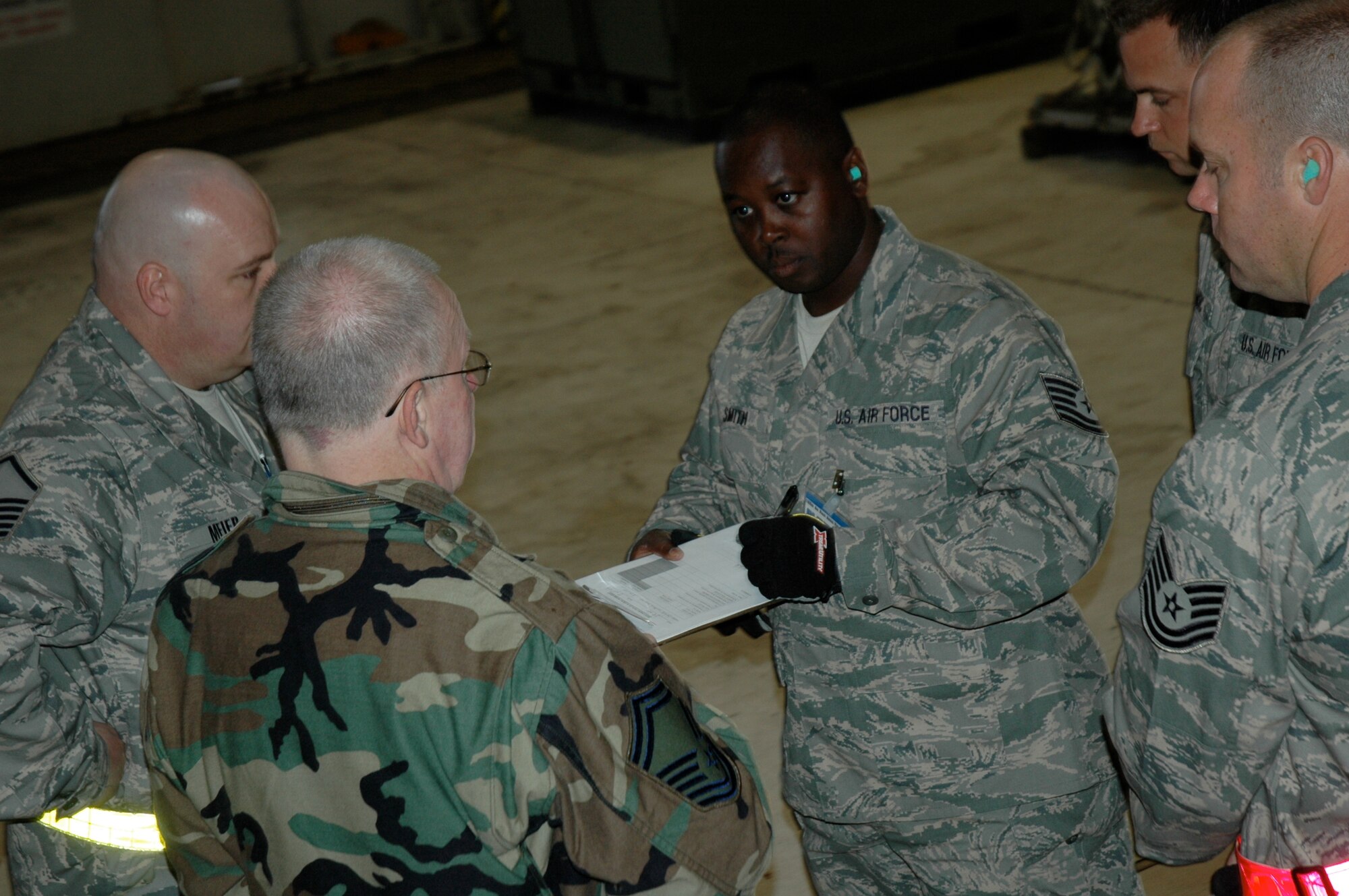 Tech. Sgt. Reginald Smith, 38th Aerial Port Squadron ROUNDUP team leader, receives instructions from upmires during the joint inspection event at the 22nd Air Force Aerial Port ROUNDUP at Dobbins Air Reserve Base in Atlanta March 15. During the competition 18 aerial port squadrons from the 22 AF vied for the top spot in six events, which test their efficiency and safety in various aerial port functions. (U.S. Air Force photo/Capt. Bryan Lewis)  