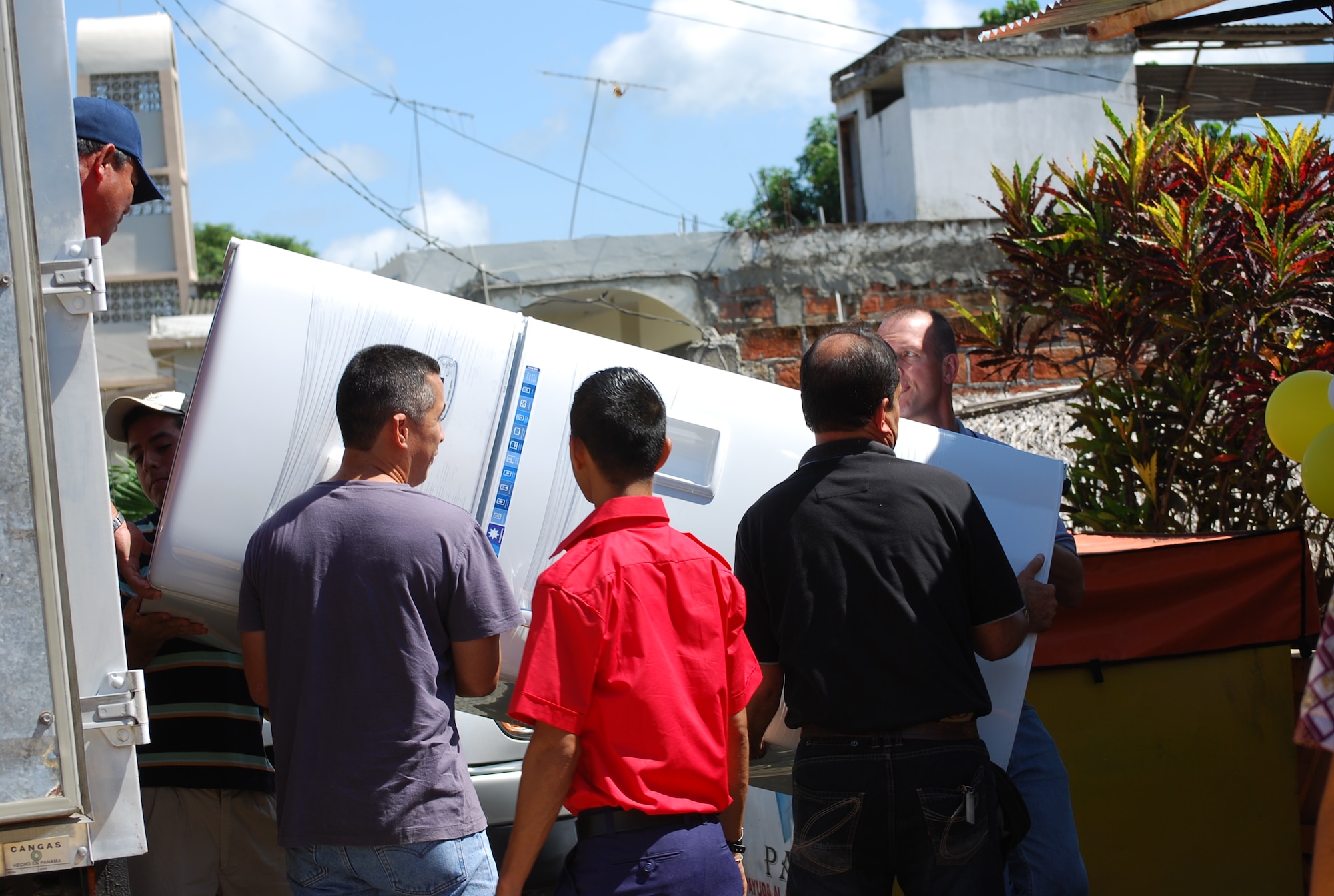 FOL Manta personnel unload a refrigerator and other materials at a Colón, Ecuador, daycare March 13. The delivery of $6,000-worth of materials was made possible through U.S. Southern Command's Humanitarian Assistance Program. HAP partners with local organizations to help strengthen and prosper the region, and aid is typically in the form of infrastructure and education improvements, donations, or disaster preparedness and relief efforts. (U.S. Air Force/1st Lt. Beth Woodward)

