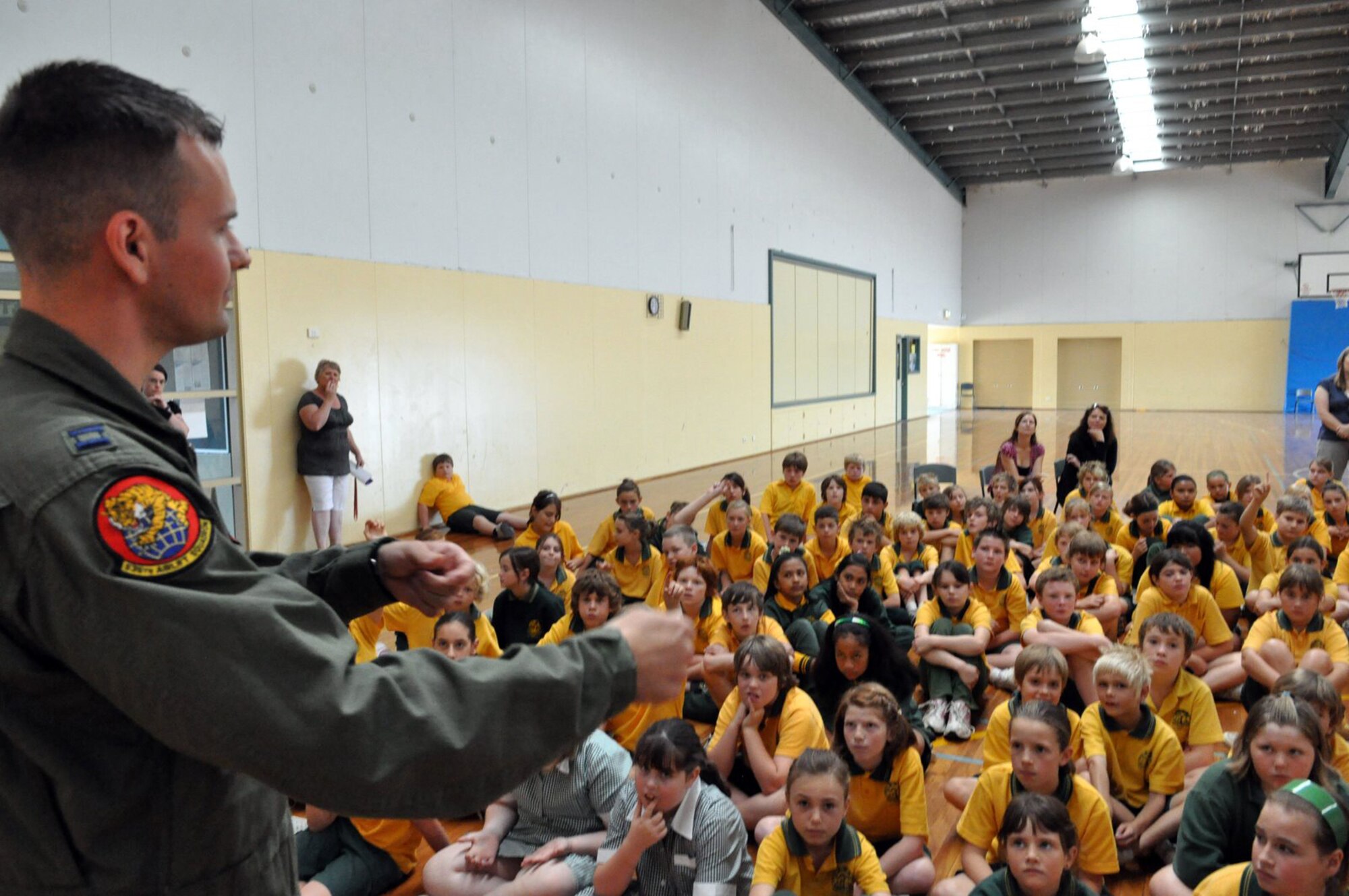 GEELONG, Victoria, Australia -- C-17 Globemaster pilot Capt. Grahm Boutz from the 535th Airlift Squadron at Hickam Air Force Base, Hawaii, visits with excited young students of Lara Primary School in nearby Lara March 12. Captain Boutz visited the school with several Air Force aviators and talked to the Australian students ages 5 and 6, and 11 and 12 about their lives in the U.S. Air Force. Captain Boutz is here with his C-17 crew to support the 2009 Australian International Airshow held at Avalon Airport near here.The show has been held every second year since 1989. (U.S.  Air Force photo/Tech Sgt. Cohen A. Young) 
