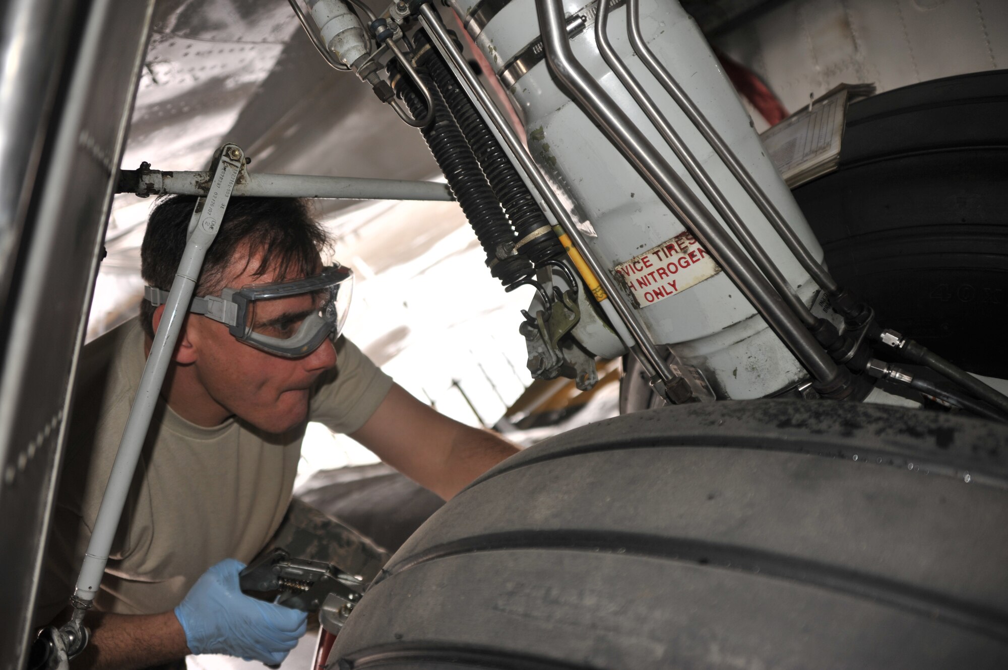 Scott AFB, IL--Tech. Sgt. Rick Bommarito, 932nd Maintenance Squadron, applies lubricant to the C9-C landing gear.  The C-9C is used for distinguished visitor airlift.  The aircraft is one of three assigned to the 932nd Airlift Wing.  The 932nd is the sole Air Force Reserve unit whose mission is to transport military and government leaders around the world.  U.S. Air Force photo/Tech. Sgt. Dan Oliver