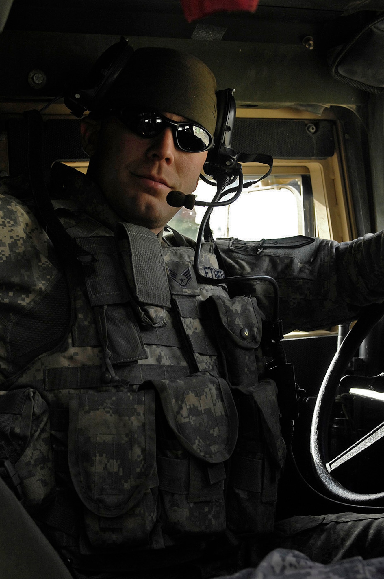 Staff Sgt. Patrick Etheridge, Kapisa/Parwan Provincial Reconstruction Team operations non-commissioned officer, helped plan and organize a convoy mission from Bagram Air Field to Mahmood Raqi, Afghanistan, March 14. The career network infrastructure instructor from Keesler Air Force Base, Miss., also served as a convoy driver as the unit visited various construction projects contracted by U.S. and coalition forces. The mission of the PRT teams in Afghanistan is to improve the country's infrastructure and provide jobs for local residents. Sergeant Etheridge's hometown is Houston, Texas. (U.S. Air Force photo by Staff Sgt. Jason Lake) 