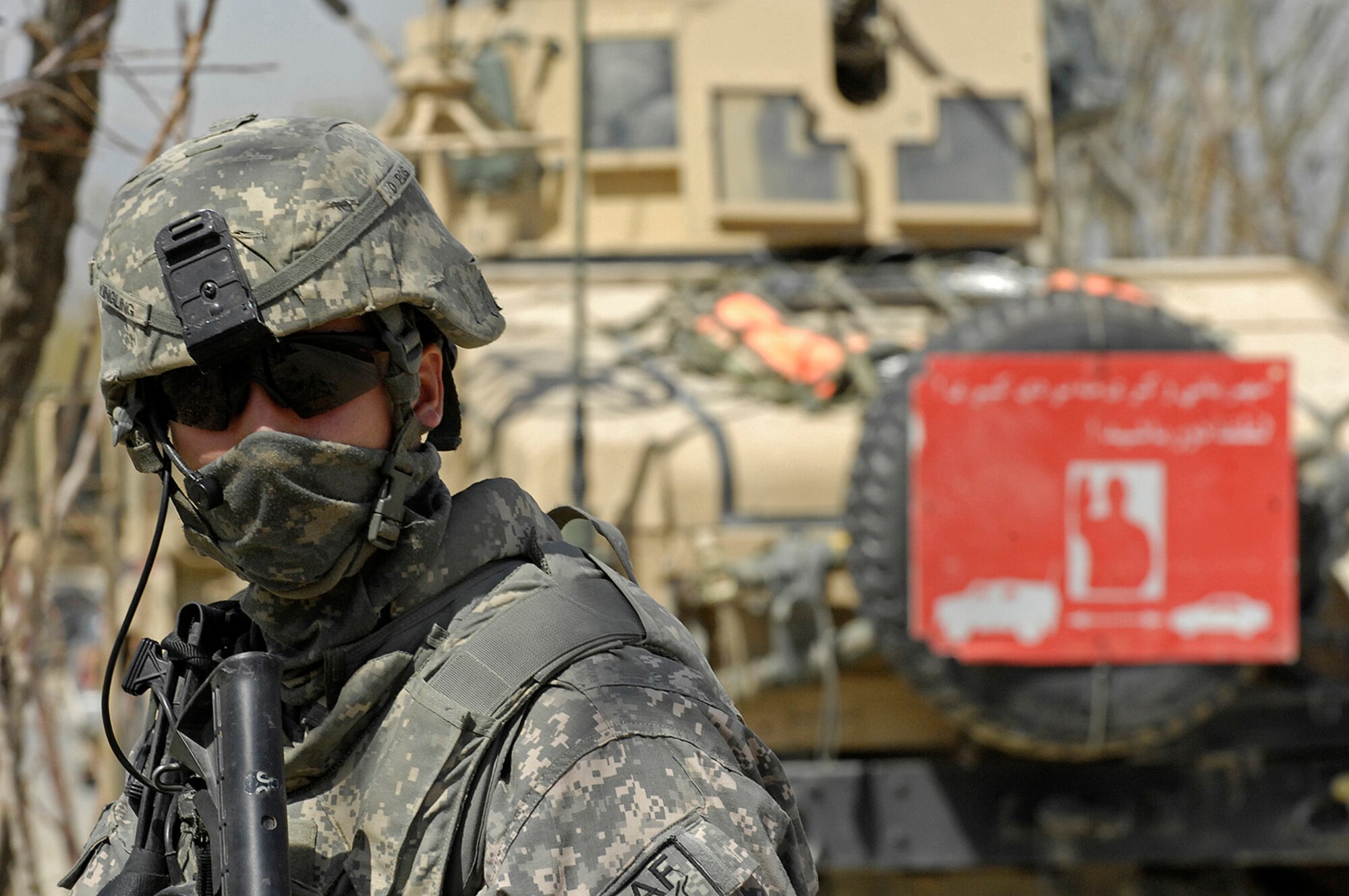 Army Sgt. Bradley Yingling, Kapisa/Parwan Provincial Reconstruction Team squad leader, provides security beside a convoy as Soldiers and Airman check a nearby bridge for damage and potential booby traps. More than a dozen U.S. Soldiers, Airmen and two civilian translators from the PRT at Bagram Air Field convoyed to several locations near Mahmood Raqi to monitor the progress of local contractors building schools, clinics and other basic infrastructure. The various construction projects contracted by U.S. and coalition forces aim to improve the country's infrastructure while also providing jobs for local residents. Sergeant Yingling is deployed to Bagram Air Field from Charlie Company, 1st Battalion, 178th Infantry, Kankakee, Ill. His hometown is Sandwich, Ill.  (U.S. Air Force photo by Staff Sgt. Jason Lake)