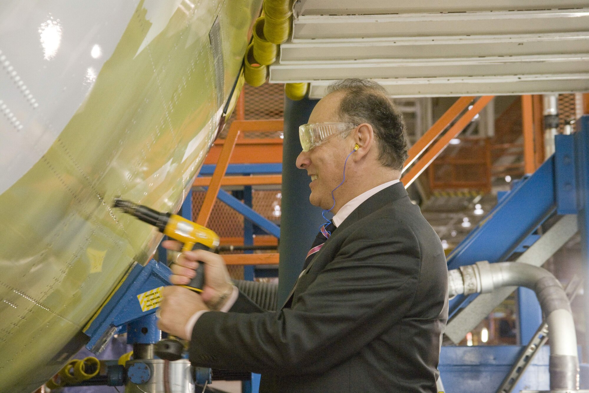 Hungarian Minister of Defense Dr. Imre Szekeres drives a ceremonial rivet into the airframe of the first C-17 Globemaster III the 12-nation Strategic Airlift Capability consortium will receive this summer. The Republic of Hungary played a significant role in the "major join" ceremony of the C-17 given the country has provided Papa Air Base, Hungary, as the SAC program's main operating base and will serve as the flag nation in registering the SAC aircraft. (Courtesy photo)