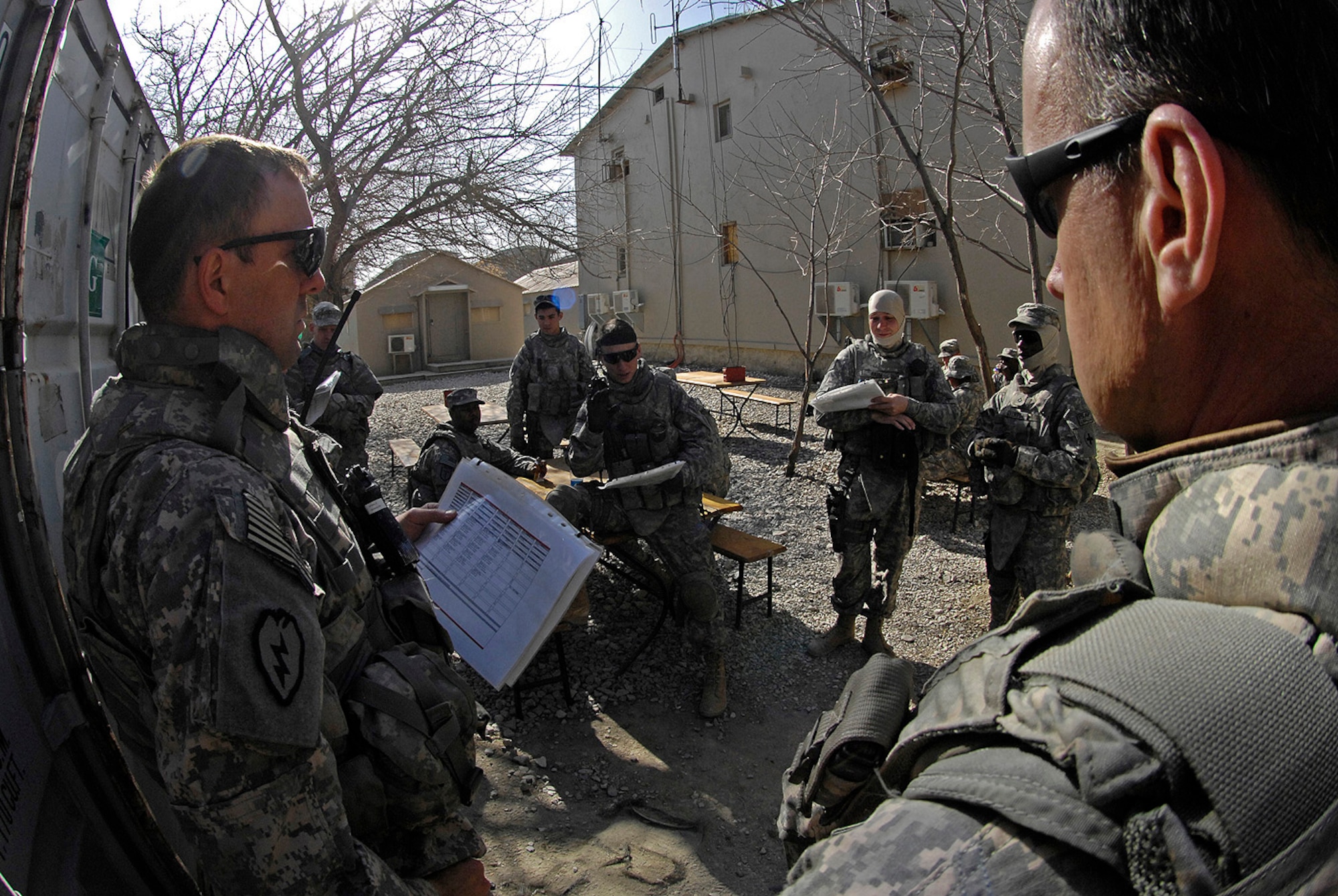 Army Sgt. Bradley Yingling, squad leader for the Kapisa/Parwan Provincial Reconstruction Team at Bagram Air Field, briefs Airmen and Soldiers prior to a convoy mission to Mahmood Raqi, Afghanistan, March 14. More than a dozen PRT members took part in the mission to visit several coalition-sponsored construction projects and met with elected members of the Kapisa Provincial Development Council to discuss security matters and community concerns. Sergeant Yingling is deployed to Bagram Air Field from Charlie Company, 1st Battalion, 178th Infantry, Kankakee, Ill. His hometown is Sandwich, Ill. (U.S. Air Force photo by Staff Sgt. Jason Lake)