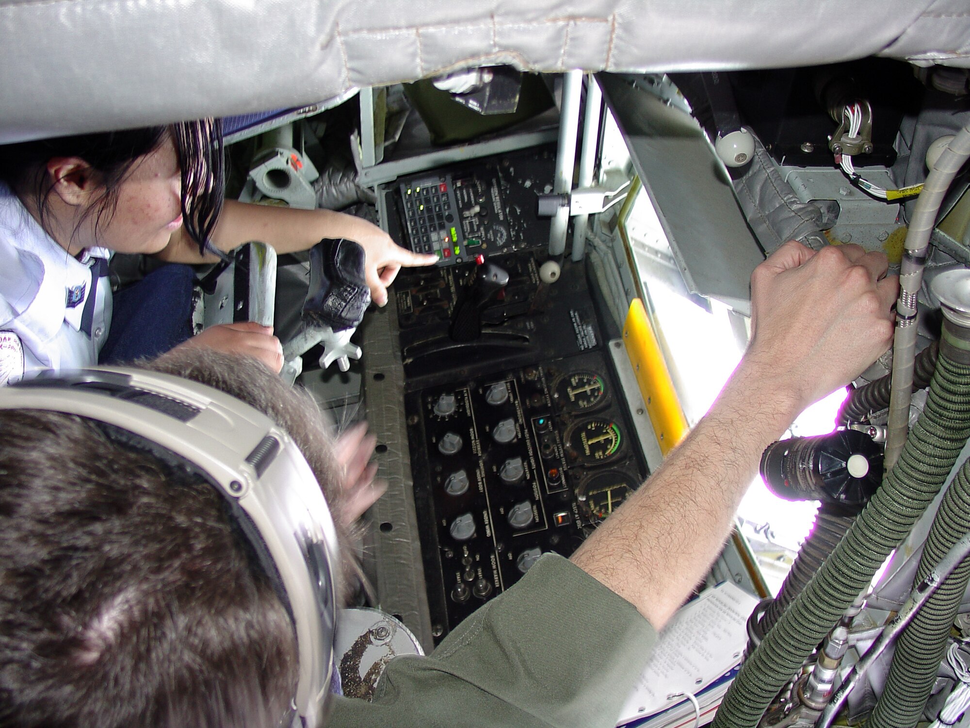 ALTUS AIR FORCE BASE, Okla. -- Master Sgt. Ernest Burns (bottom), 55th Air Refueling Squadron KC-135 boom instructor, shows Cadet Tech. Sgt. Sandra Garcia, a junior at Crooked Oaks High School in Oklahoma City, the controls of the boom. The 29 students on the orientation flight learned about the KC-135's vital role in the Air Force and its capabilities. (U.S. Air Force photo by Senior Airman Clinton Atkins)