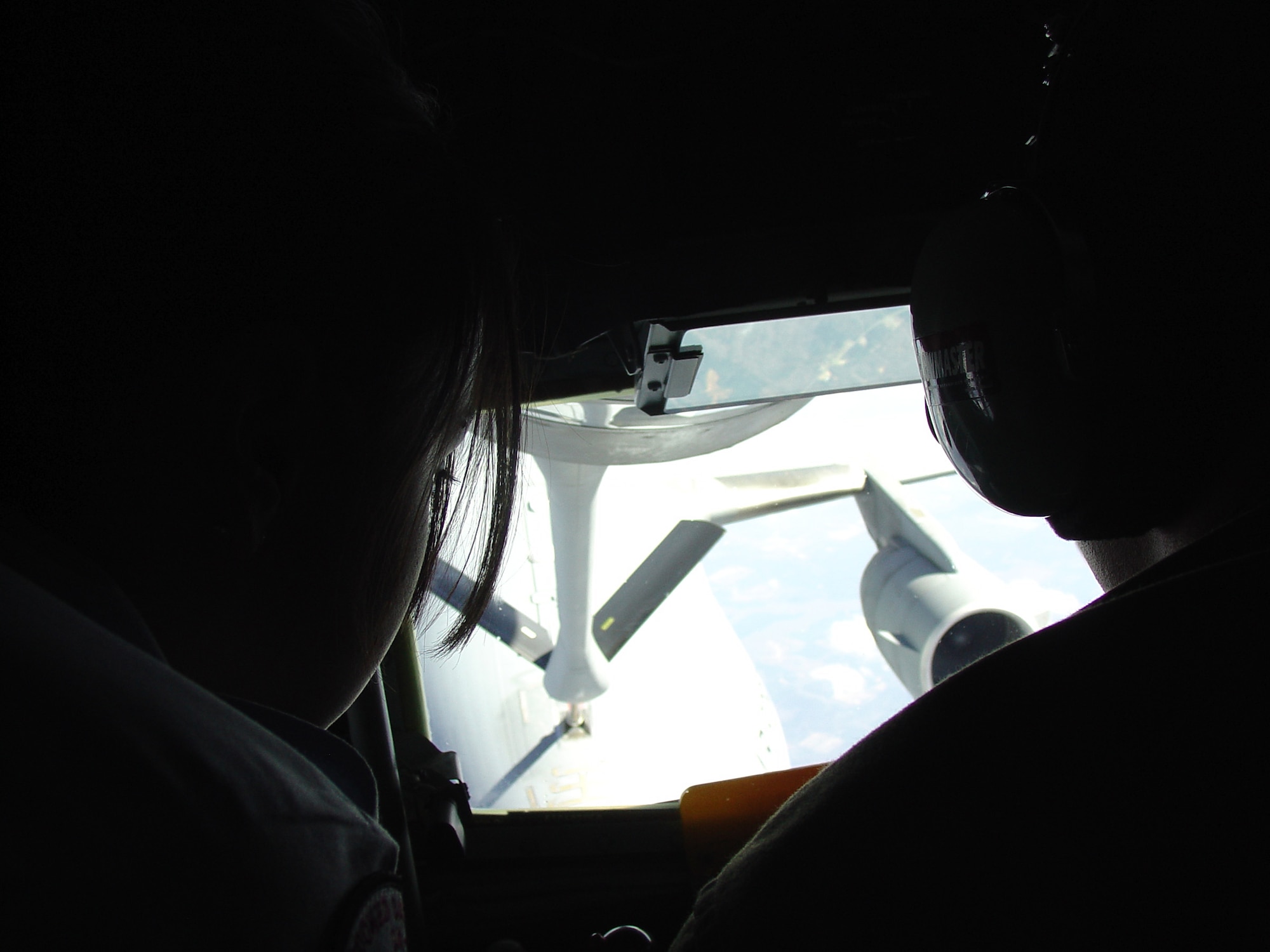 ALTUS AIR FORCE BASE, Okla. -- Cadet Airman 1st Class Ruby Garcia (left), a freshman Junior ROTC student from Crooked Oaks High School in Oklahoma City, observes Staff Sergeant Clayton Lifer, 55th Air Refueling Squadron KC-135 boom instructor, as he refuels a C-17 Globemaster III. All of the 29 Air Force JROTC students were able to witness the capabilities of a KC-135 Stratotanker. (U.S. Air Force photo by Senior Airman Clinton Atkins)