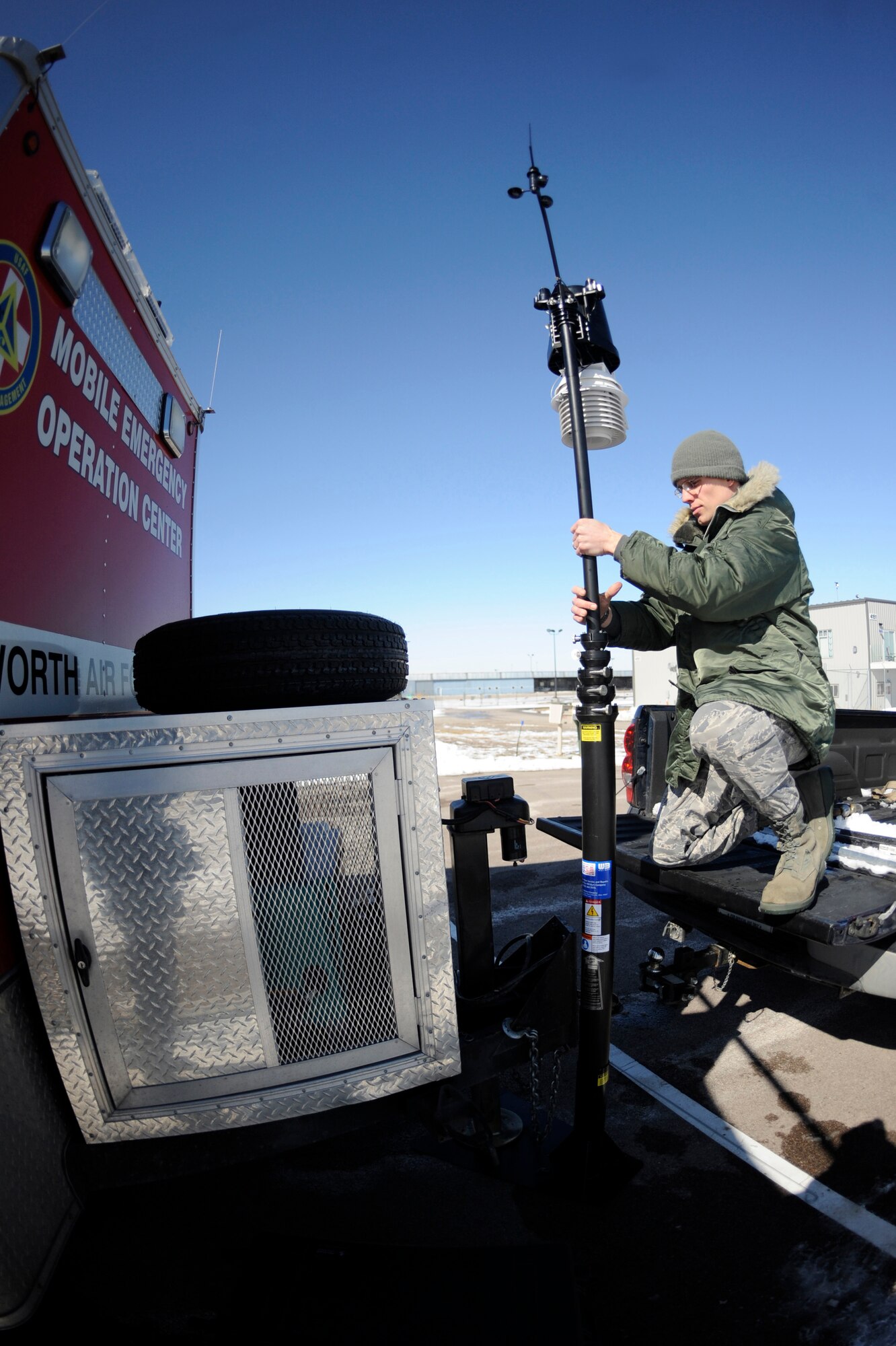 Senior Airman Daniel Van Stone, 28th Civil Engineer Squadron emergency management technician, sets up a weatherpak during an antiterrorism exercise at Rapid City Regional Airport, S.D., March 12.  The weatherpak extracts local weather information from the air to provide the mobile emergency operations center with the most up to date weather information. Ellsworth Airmen teamed up with their civilian counterparts during the exercise, in an effort to develop a working relationship and become familiar with the policies and procedures of each other. (U.S. Air Force photo/Airman 1st Class Matthew Flynn)
