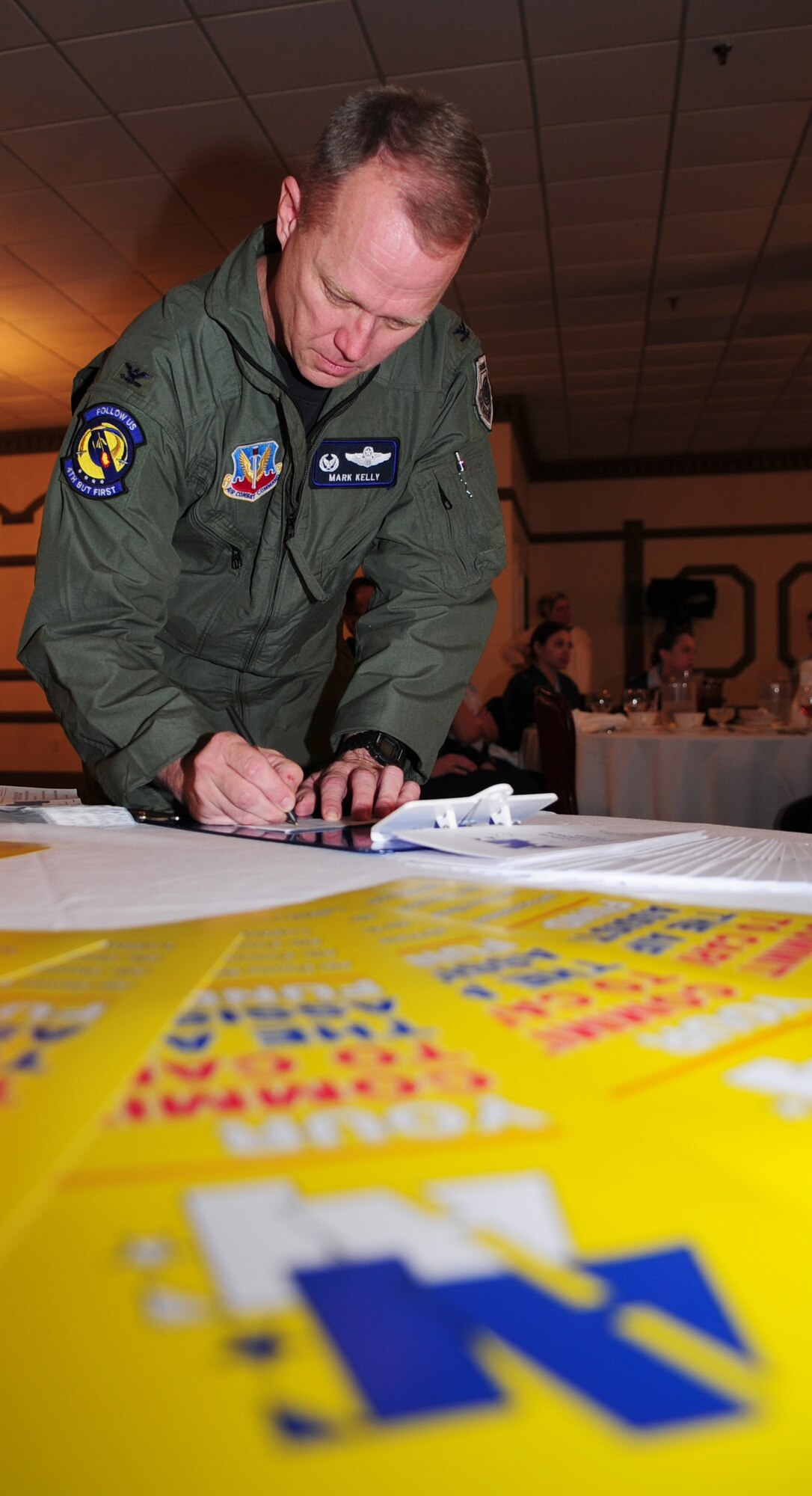 Colonel Mark D. Kelly, 4th Fighter Wing commander, signs the first donation slip for the Air Force Assistance Fund to kick of this year’s campaign at Seymour Johnson Air Force Base, N.C., March 16, 2009. The fund allows Airmen to assist victims of natural disaster or experience a family crisis. (U.S. Air Force Photo by Airman 1st Class Rae Perry)