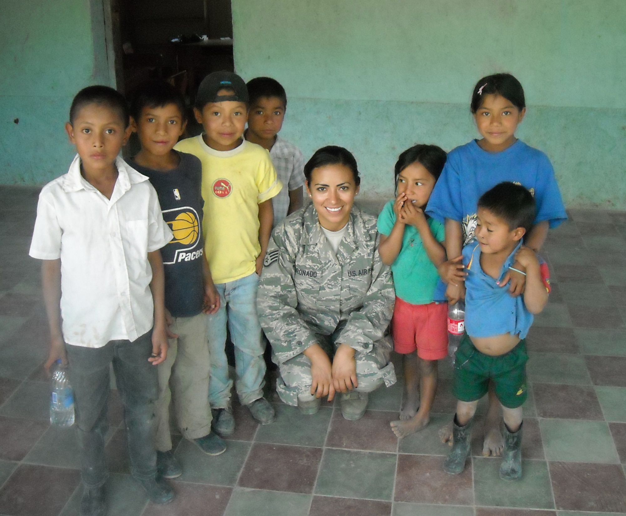 Local children join Staff. Sgt. Marina Coronado for a photo during her four-month deployment to Honduras. She received a Joint Service Achievement Medal on March 14 for accomplishments while deployed. Sergeant Coronado is an information manager assigned to the 931st Operations Support Flight, an Air Force Reserve unit at McConnell Air Force Base, Kan. (Courtesy photo)  