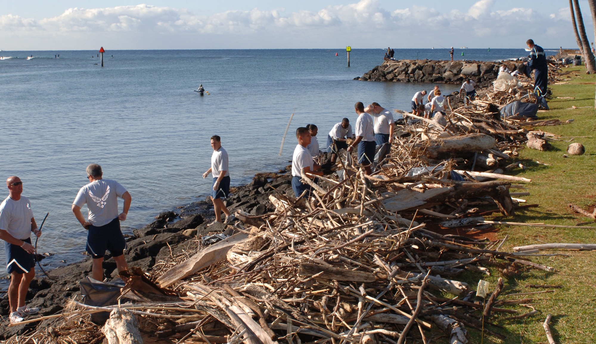 Airmen from 13th Air Force at Hickam Air Force Base, Hawaii, clean trash and debris from the rocky shoreline March 13 along Ala Moana Beach Park in Honolulu. The Airmen volunteered for the beach cleanup as part of 13th Air Force's Jungle Day, a tradition for the unit that occurs every Friday the 13th. (U.S. Air Force photo/Oscar A. Hernandez) 
