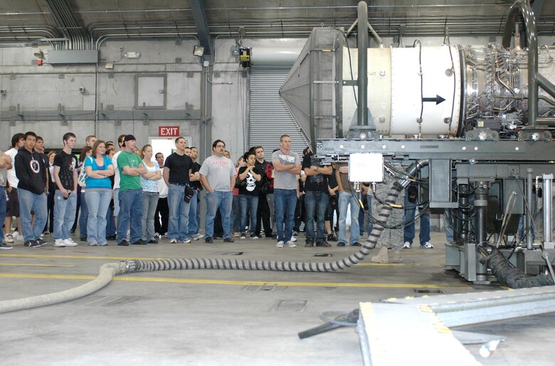 "Bring a Buddy to Drill” participants stand in awe before an F-16 jet engine in the hush house prior to an engine test demonstration, March 7. The success of the recruiting event hinges on wing members inviting friends and family to see what the Guard is like. (Air National Guard photo by Capt. Gabe Johnson)