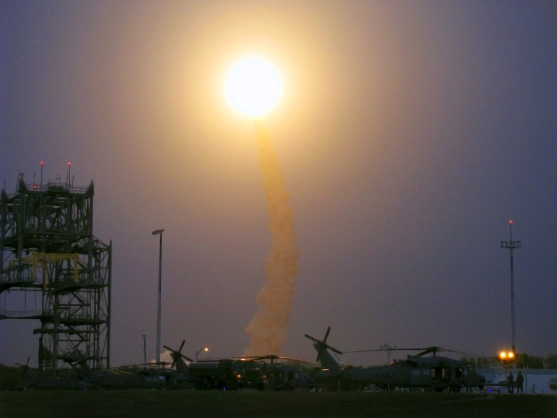 KENNEDY SPACE CENTER, Fla. -- Space Shuttle Discovery hurtles through the stratosphere under the watchful eyes of 920th Rescue Wing helicopter crewmembers here March 15. The reservists provide first-response, emergency medical and search-and-rescue support for all NASA shuttle and rocket launches. The reservists are also responsible for clearing the Eastern Range of ocean traffic prior to each launch. The Eastern Range refers to the roughly 10-mile-wide by 70-mile-long strip of Atlantic Ocean that extends out from the launch pad in the anticipated direction of flight, or “launch azimuth.” (U.S. Air Force photo/Lt. Col. Robert Haston)