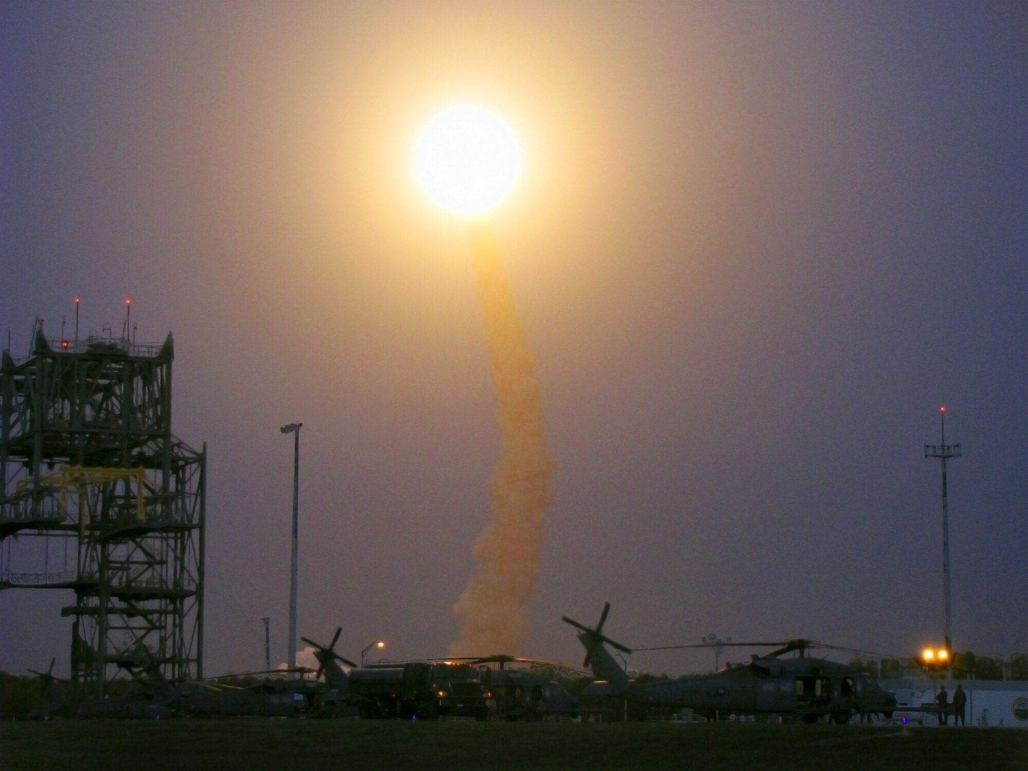 KENNEDY SPACE CENTER, Fla. -- Space Shuttle Discovery hurtles through the stratosphere under the watchful eyes of 920th Rescue Wing helicopter crewmembers here March 15. The reservists provide first-response, emergency medical and search-and-rescue support for all NASA shuttle and rocket launches. The reservists are also responsible for clearing the Eastern Range of ocean traffic prior to each launch. The Eastern Range refers to the roughly 10-mile-wide by 70-mile-long strip of Atlantic Ocean that extends out from the launch pad in the anticipated direction of flight, or “launch azimuth.” (U.S. Air Force photo/Lt. Col. Robert Haston)