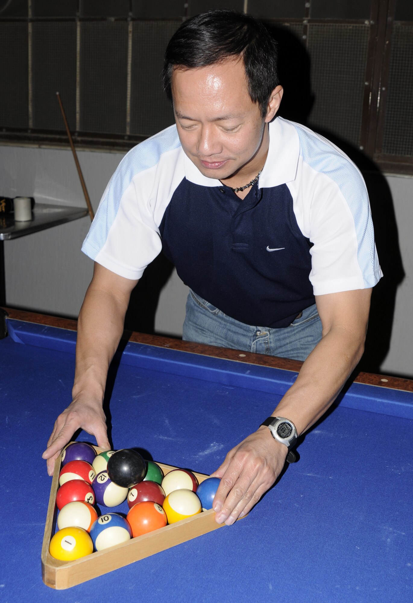 Andy Trillo, 39th Comptrollers Squadron, sets up the rack before his game during the eight-ball pool tournament at the Consolidated Club March 12. More than 15 participants competed for a first place prize of a $150 cash, and a custom pool stick for second and third place prizes. (U.S. Air Force photo/Airman 1st Class Amber Russell)
