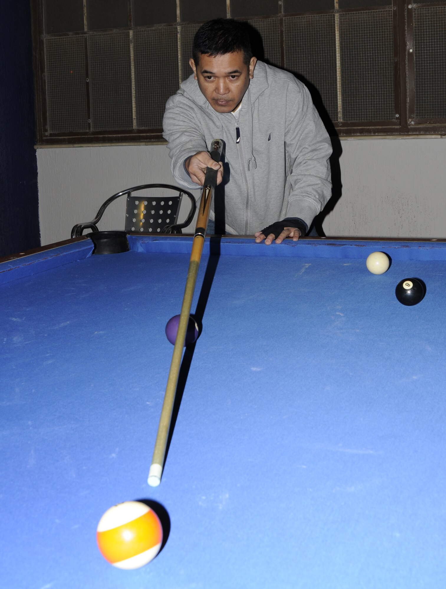 Tech Sgt. Frederick Polidario, 39th Civil Engineer Squadron, judges where he should aim to shoot his ball during the eight-ball pool tournament at the consolidated club March 12. More than 15 participants competed for a first place prize of a $150 cash, and a custom pool stick for second and third place prizes. (U.S. Air Force photo/Airman 1st Class Amber Russell)