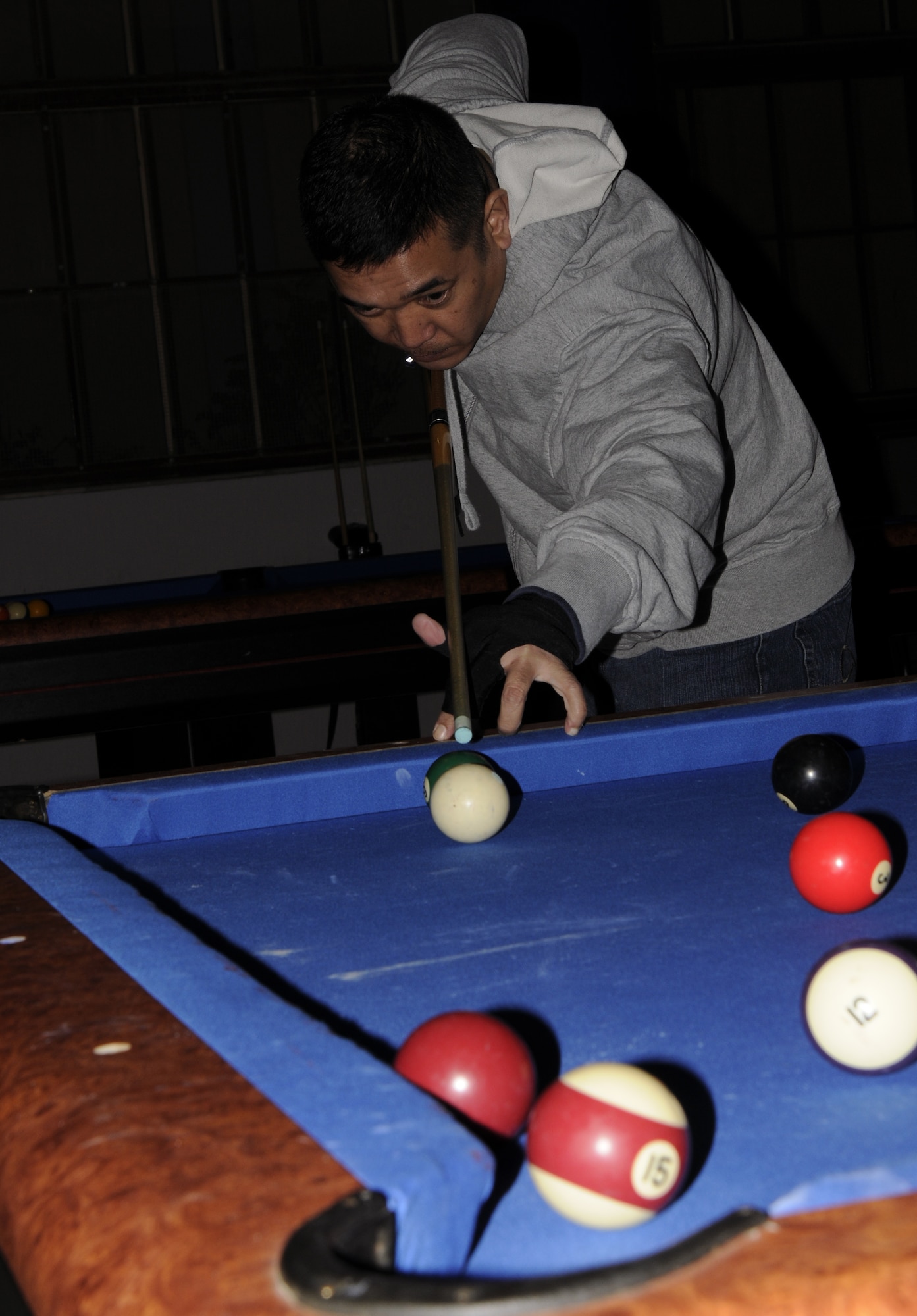 Tech Sgt. Frederick Polidario, 39th Civil Engineer Squadron, aims to get his ball in during the eight-ball pool tournament at the Consolidated Club March 12.  There were brackets set up for play, a loser’s bracket included, for a first, second and third place winner. (U.S. Air Force photo/Airman 1st Class Amber Russell)