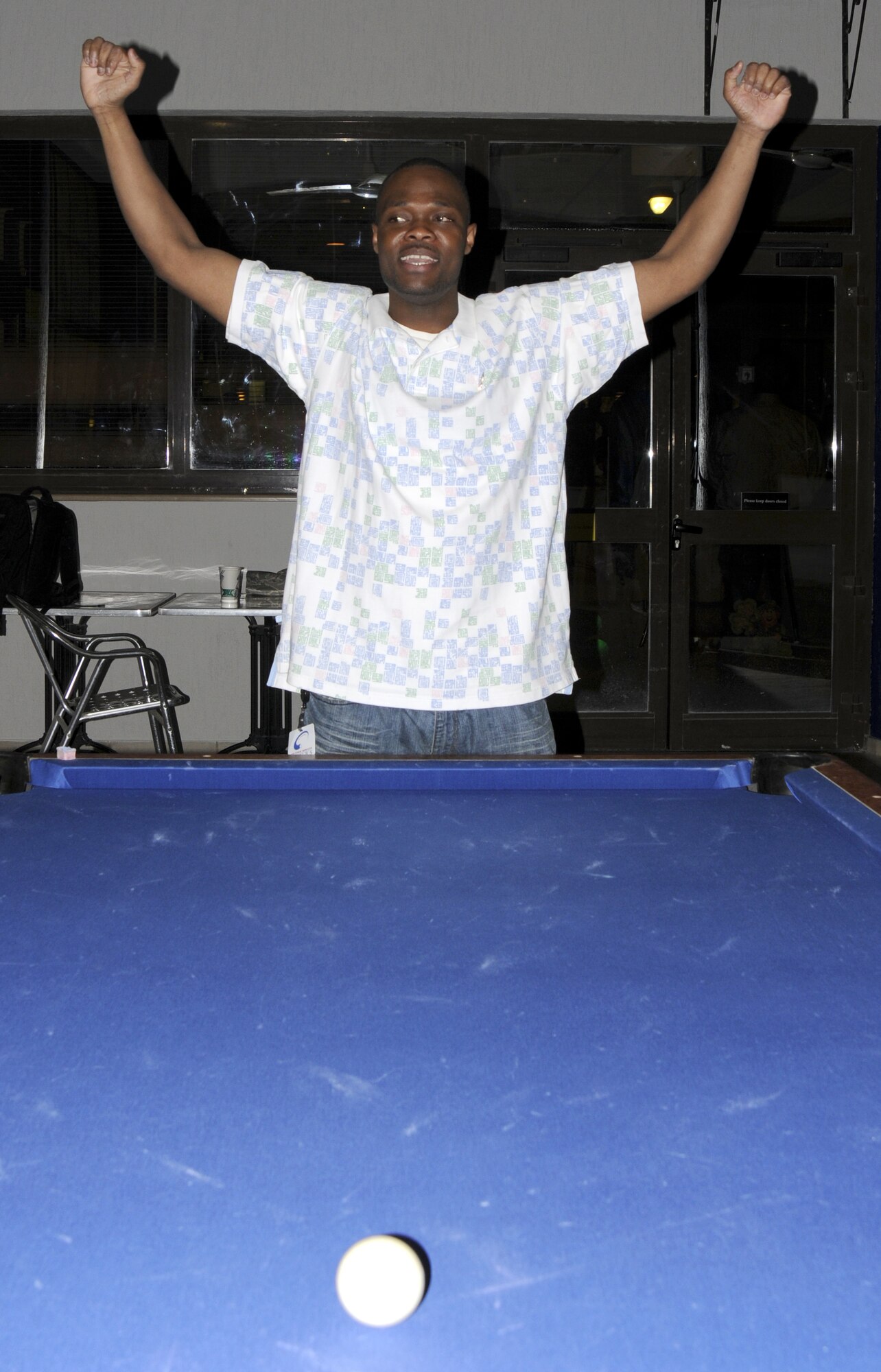 Senior Airman Jude Jean, 39th Logistics Readiness Squadron, gives a celebratory pose when he finds out he’ll be going to the next round during the eight-ball pool tournament at the Consolidated Club March 12. More than 15 participants competed for a first place prize of a $150 cash, and a custom pool stick for second and third place prizes. (U.S. Air Force photo/Airman 1st Class Amber Russell)