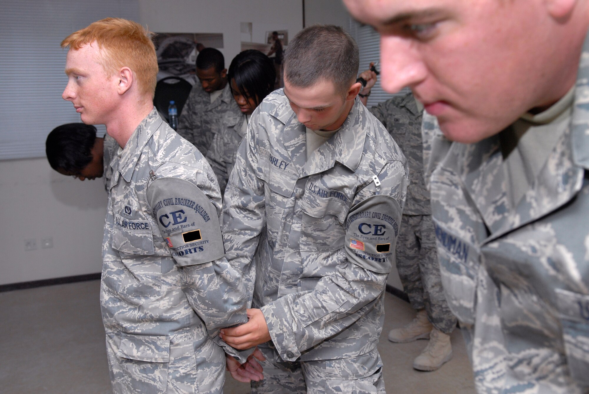 Senior Airman Andrew Farley, a 379th Expeditionary Civil Engineer Third Country National Escort, searches an airman for weapons and contraband during a training course with Security Forces, Mar. 13, 2009, at an undisclosed location in Southwest Asia.  Airman Farley hails from Princeton, W. Va. and is deployed from Nellis Air Force Base, Nev. in support of Operations Iraqi and Enduring Freedom and Combined Joint Task Force - Horn of Africa.  (U.S. Air Force Photo by Senior Airman Andrew Satran/Released)