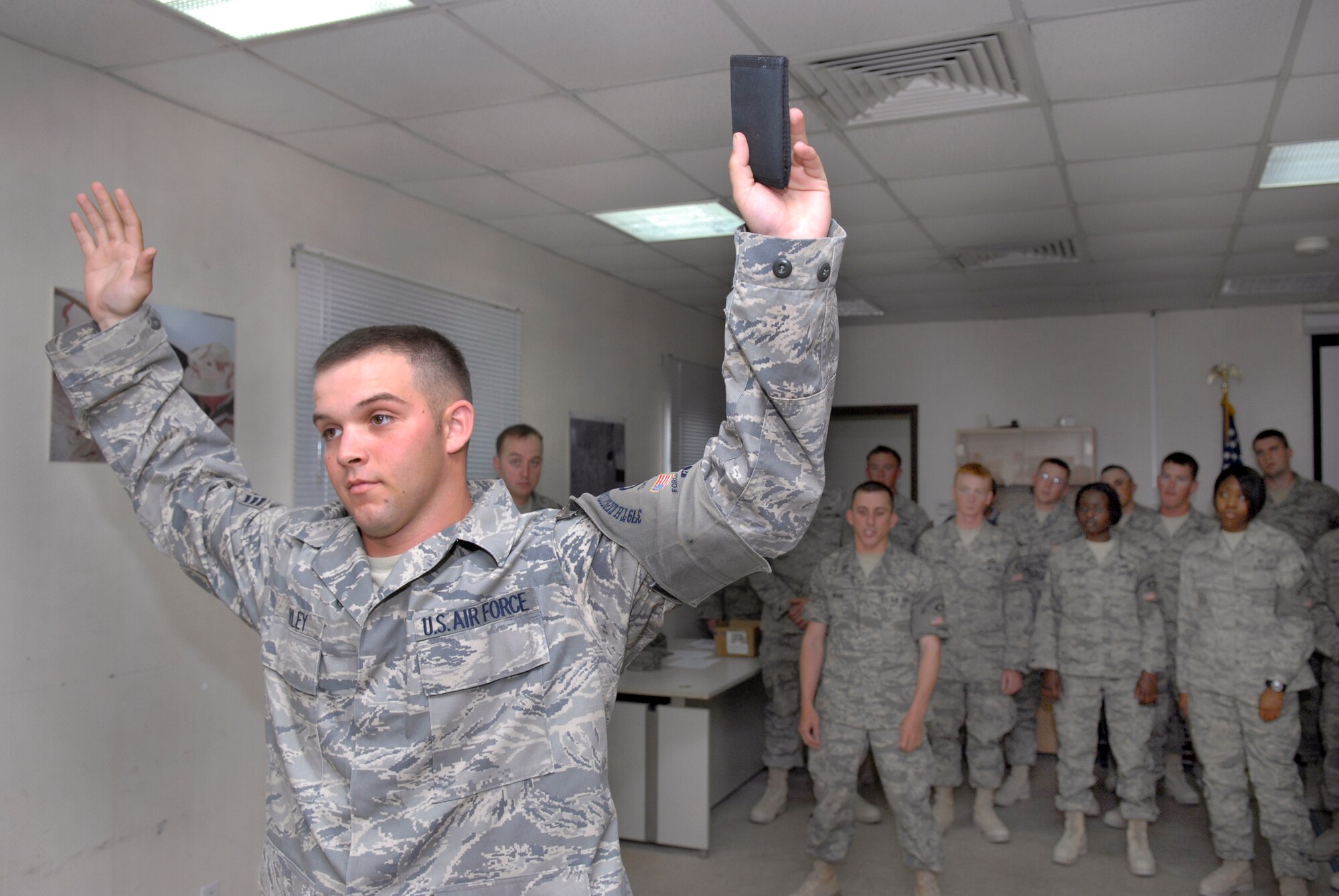 Senior Airman Andrew Farley, a 379th Expeditionary Civil Engineer Third Country National Escort, holds his identification up in the challenge position during a training course with Security Forces, Mar. 13, 2009 at an undisclosed location in Southwest Asia.  Airman Farley hails from Princeton, W. Va. and is deployed from Nellis Air Force Base, Nev. in support of Operations Iraqi and Enduring Freedom and Combined Joint Task Force - Horn of Africa.  (U.S. Air Force Photo by Senior Airman Andrew Satran/Released)
