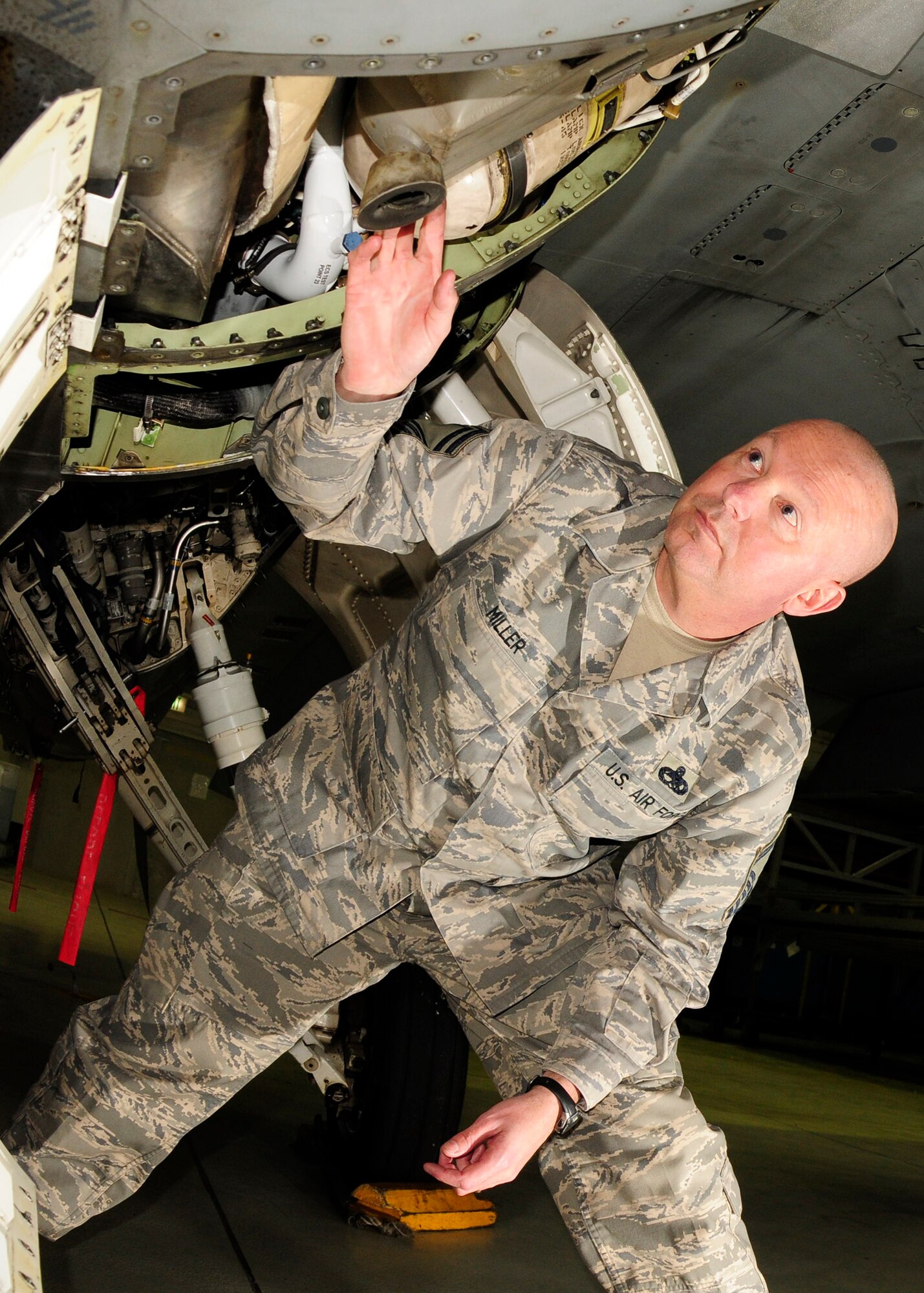 SPANGDAHLEM AIR BASE, Germany - Senior Master Sgt. Charles Miller inspects F-16 landing gear on the hydraulic line, March 3, 2009. This is done to ensure that everything is tightly secured and that there is no damage to the gear. Sergeant Miller was named the 2008 Air Force Lt. Gen. Leo Marquez Senior Noncommissioned Officer of the Year. (U.S. Air Force photo by Airman 1st Class Nicholas Wilson)