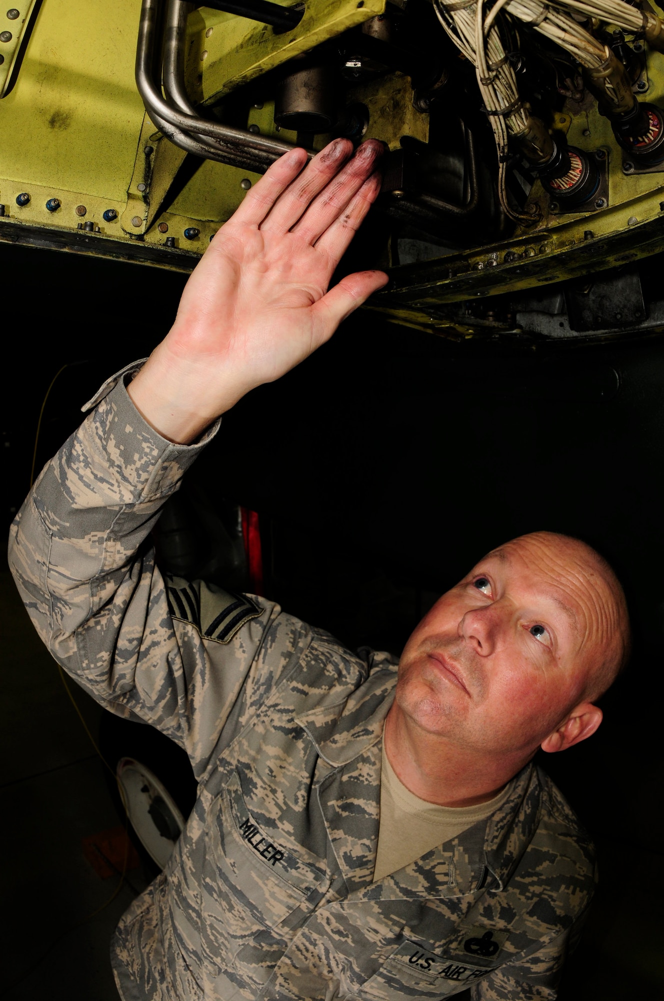 SPANGDAHLEM AIR BASE, Germany - Senior Master Sgt. Charles Miller, 52nd Equipment Maintenance Squadron, inspects F-16 hydraulics system tubing, March 3, 2009. This is done to ensure that the tubing is not damaged or twisted. Sergeant Miller was named the 2008 Air Force Lt. Gen. Leo Marquez Senior Noncommissioned Officer of the Year. (U.S. Air Force photo by Airman 1st Class Nicholas Wilson))