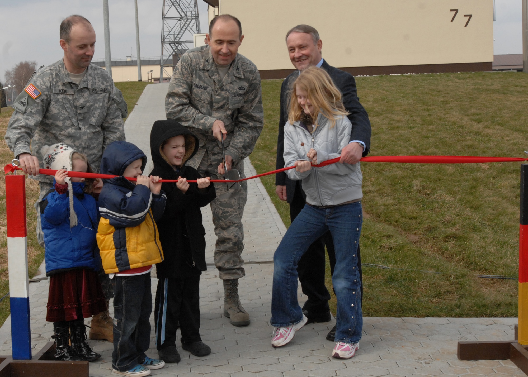 SPANGDAHLEM AIR BASE, Germany -- Col. William Nadolski, 52nd Fighter Wing vice commander, along with members of the Army Corps of Engineers and children of wing leadership cut a ribbon during the for the new air traffic control tower March 13, 2009.  After the ceremony visitors were given a chance to look at the new tower which provides air traffic controllers a view of the entire flight line. (U.S. Air Force photo by Senior Airman Jenifer H. Calhoun)