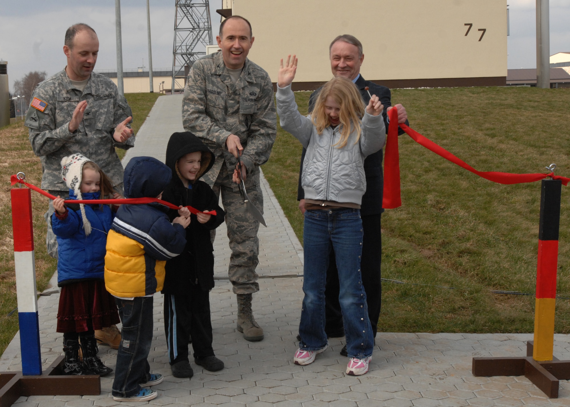SPANGDAHLEM AIR BASE, Germany -- Col. William Nadolski, 52nd Fighter Wing vice commander, along with members of the Army Corps of Engineers and children of wing leadership cut a ribbon during the for the new air traffic control tower March 13, 2009.  After the ceremony visitors were given a chance to look at the new tower which provides air traffic controllers a view of the entire flight line. (U.S. Air Force photo by Senior Airman Jenifer H. Calhoun)