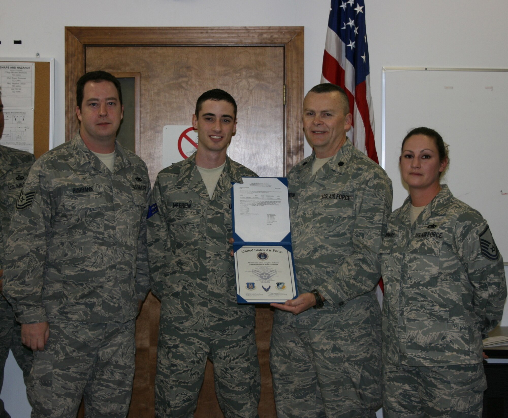 SEYMOUR JOHNSON AIR FORCE BASE, N.C. -- Reservist Joseph McGrew (second from right) is promoted to the rank of senior airman by Lt. Col. James Horton (second for left) during the March unit training assembly. Master Sgt. Jennifer Conway (left) and Tech. Sgt. Michael Burbank (right) were also present. All are members of the 916th Air Refueling Wing Communication Squadron.