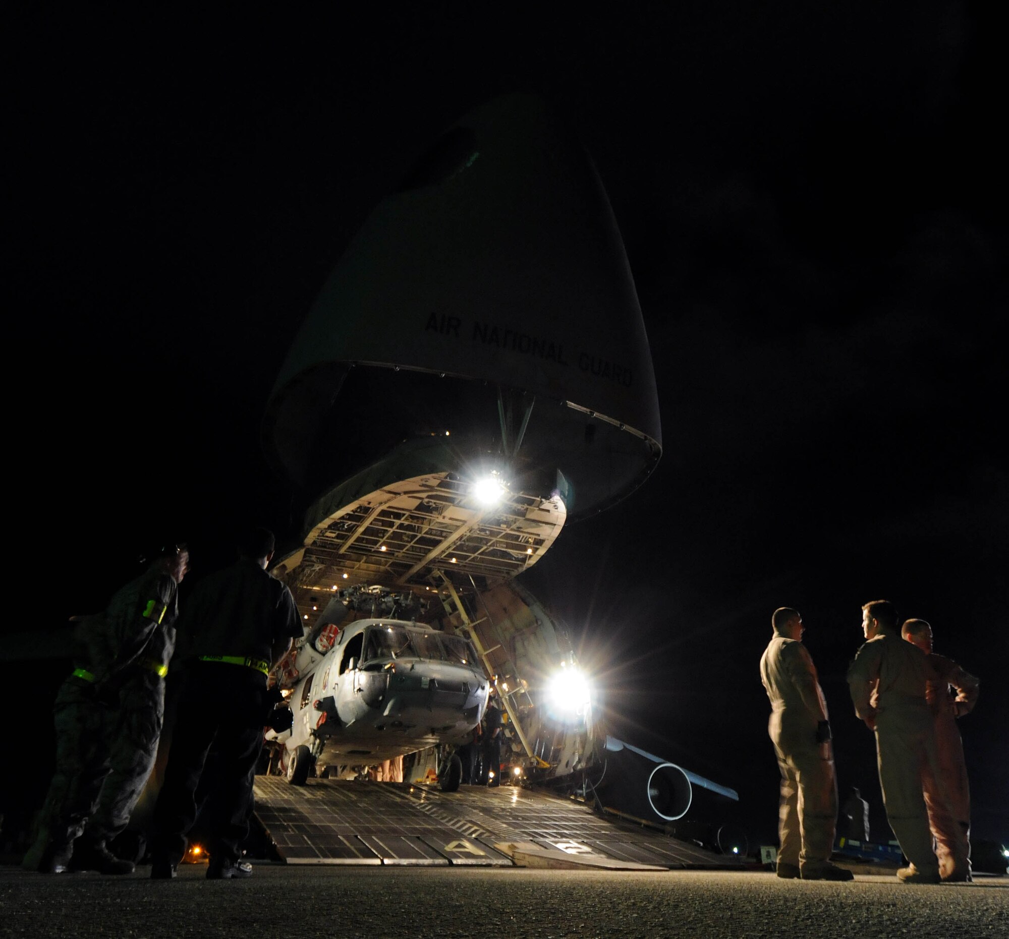 ANDSERSEN AIR FORCE BASE, Guam – A C-5 Galaxy flight crew from 167th Airlift Wing, West Virginia Air National Guard, discuss the complexities it took to load five helicopters into their aircraft on the flightline at Andersen Air Force Base, Guam, March 13, 2009. The team loaded three MH-60H Knighthawks and two SH-60H Seahawks. Not only was it the first time ever a C-5 Galaxy has loaded five of the similar-framed helicopters, but this is the second time the 167th AW has flown a complete circle around the world. (U.S. Air Force photo by Airman 1st Class Courtney Witt)