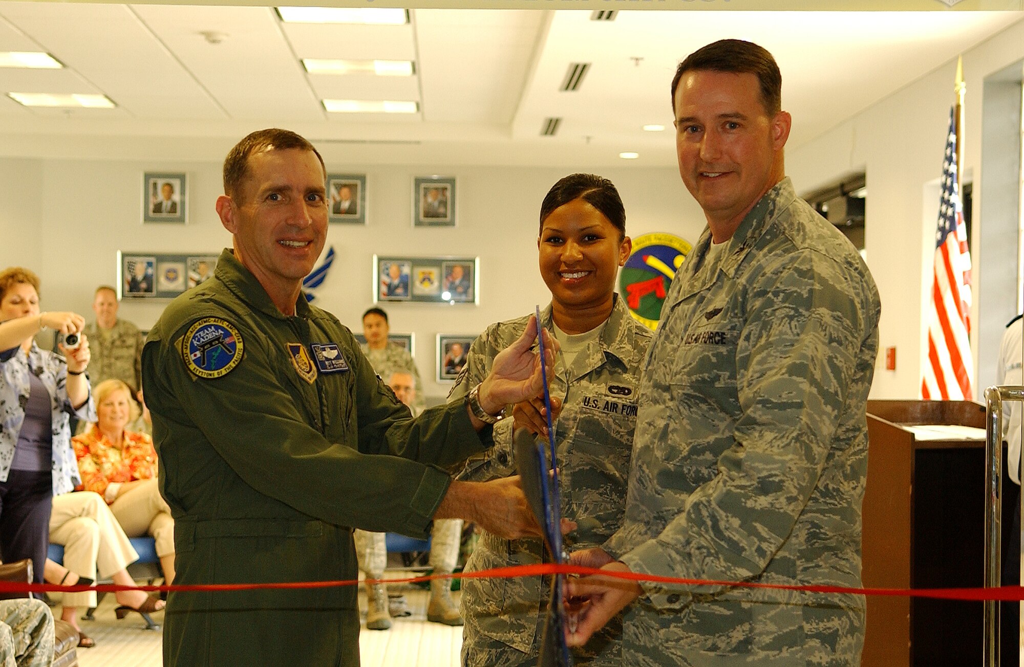 Brig. General Brett Williams, 18th Wing commander and Col. Timothy Bush,
733rd Air Mobility Squadron commander, participate in the Air Mobility
Command passenger terminal ribbon cutting ceremony March 11 at Kadena Air
Base, Japan. (U.S. Air Force photo/Tech. Sgt. Rey Ramon)   
  
