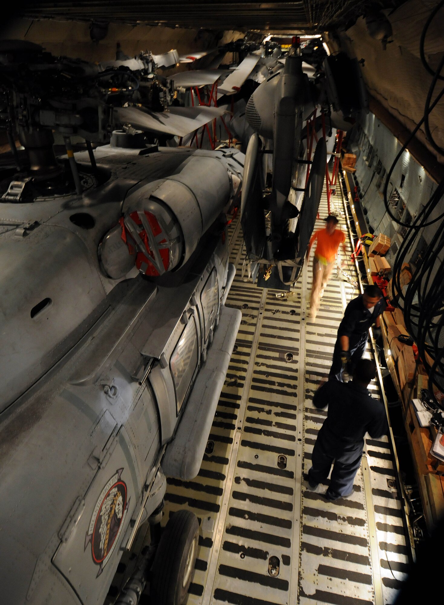ANDSERSEN AIR FORCE BASE, Guam – A load team conducts a final inspecting after loading three MH-60S and two SH-60H helicopters onto a C-5 Galaxy on the flightline at Andersen Air Force Base, Guam, March 13, 2009. Air Force load teams from 734th Air Mobility Squadron, Air National Guardsmen from the 167th Airlift Wing, Martinsburg, W. Va., and Navy sailors from Helicopter Sea Combat Squadron TWO FIVE loaded three MH-60S and two SH-60H helicopters inside the cargo aircraft for transportation to Island Naval Air Station, San Diego.  The event was the first time a C-5 aircrew has moved five of that airframe at one time.  (U.S. Air Force photo by Airman 1st Class Courtney Witt)