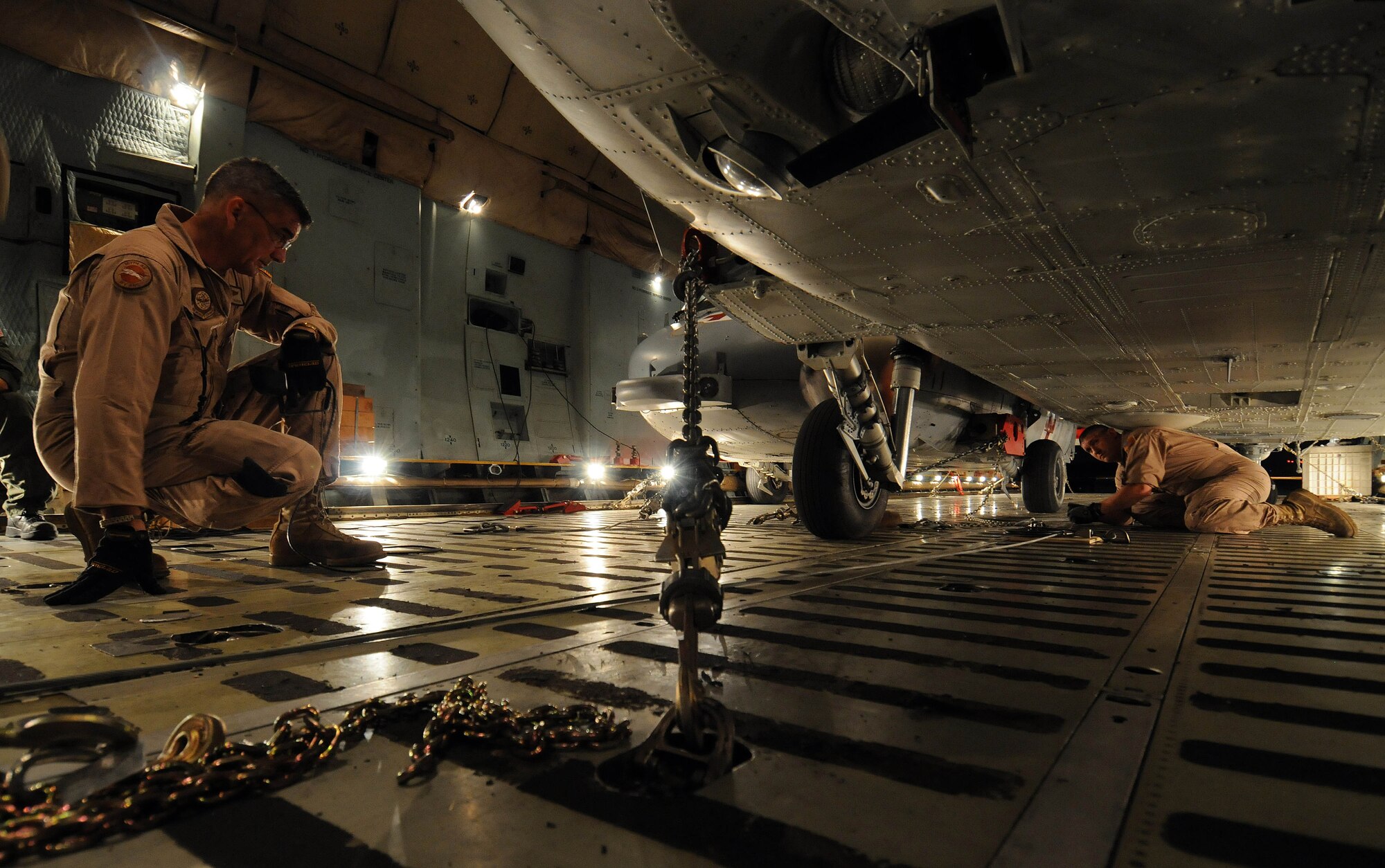 ANDSERSEN AIR FORCE BASE, Guam - Senior Master Sgt. Randall Shafer, 167th Airlift Wing load master, West Virginia Air National Guard, oversees Staff Sgt. Justin McDonald as he chains a MH-60S Knighthawk to the cargo bay of a C-5 Galaxy at Andersen Air Force Base, Guam, March 13, 2009.  A team of Airmen from the 167th AW and Andersen as well as Sailors from Helicopter Sea Combat Squadron TWO Five loaded three MH-60S and two SH-60H helicopters.  It took the load team six hours to secure the five helicopters inside C-5. (U.S. Air Force photo by Airman 1st Class Courtney Witt) 
 