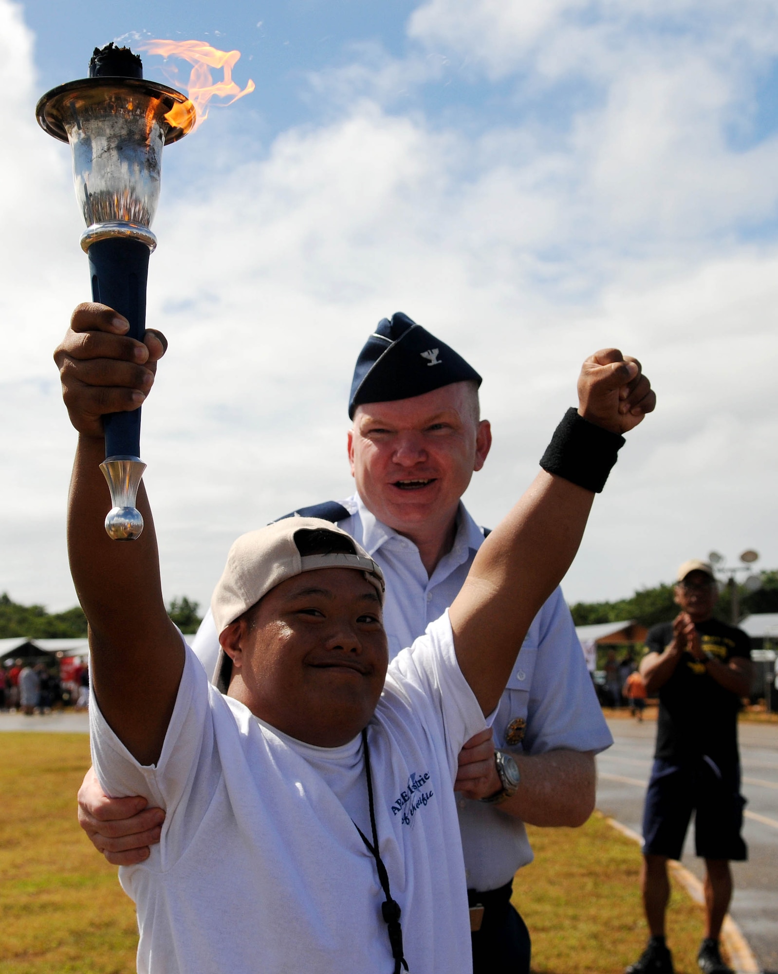 ANDERSEN AIR FORCE BASE, Guam - Andersen's 36th Mission Support Group
Commander, Col. Mark Talley, congratulates Quentin San Nicolas after his
final leg of the torch run during the 33rd Annual Special Olympics held at the Okkodo High School track March 14. Special Olympics Guam provides year-round sports training and competition in a variety of Olympic-type sports for children and adults with intellectual disabilities by giving them continuing opportunities to develop physical fitness, demonstrate courage, experience joy and participate in a sharing of gifts, skills and friendship with their families, other Special Olympics athletes and the island community. (U.S. Air Force photo by Airman 1st Class Courtney Witt)


